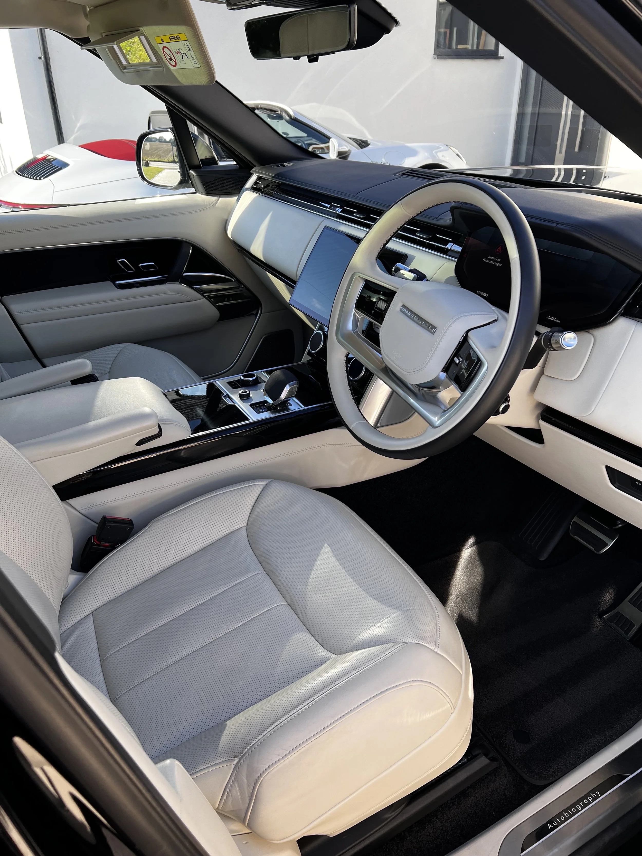 Luxury SUV interior with leather seats and touchscreen display.