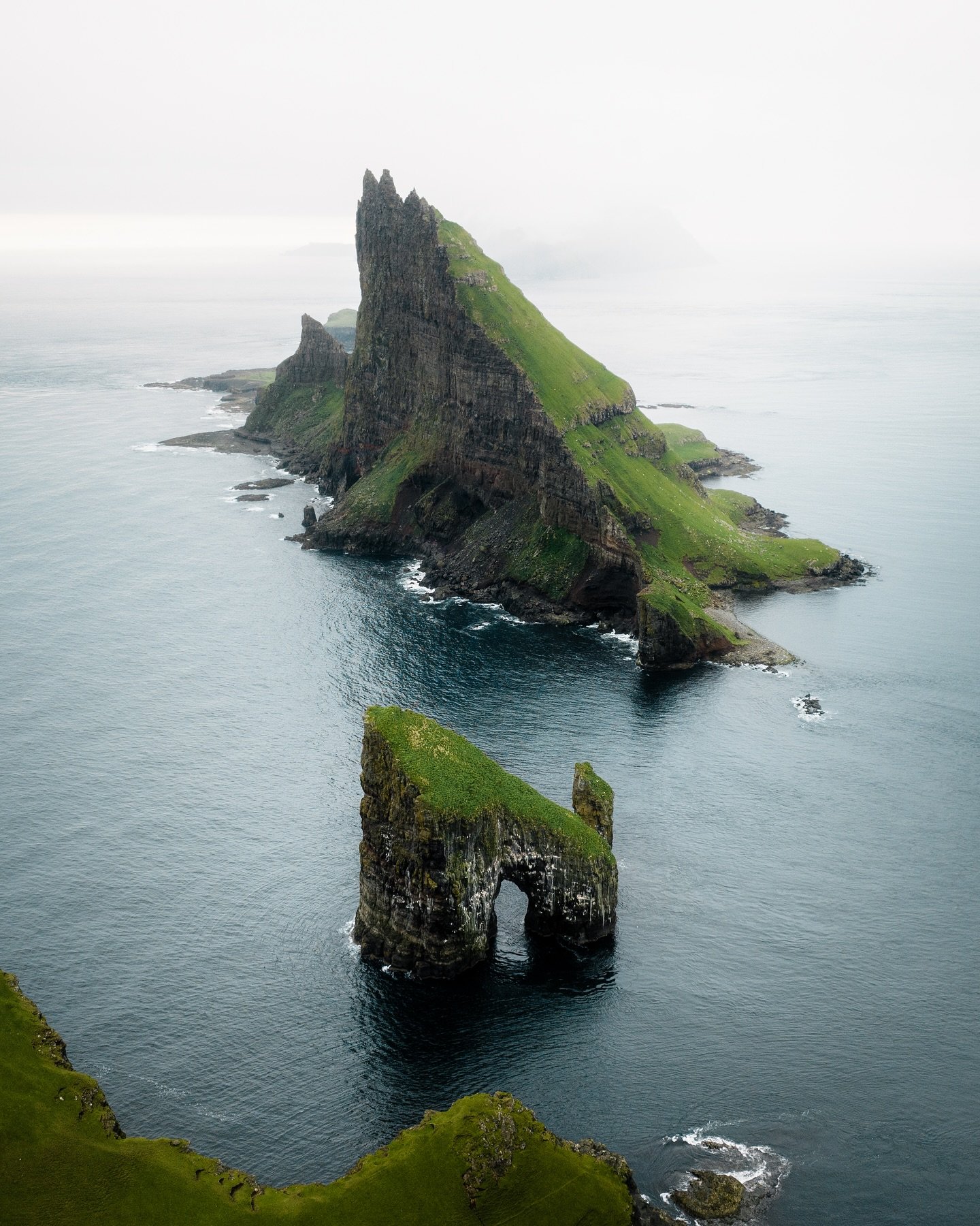 Drangarnir and Tindh&oacute;lmur are two of the most iconic sea stacks in the Faroe Islands. The greatest thing about them is that when you&rsquo;re landing on the Faroe Islands, you fly past the fjord where you can see them through the airplane wind