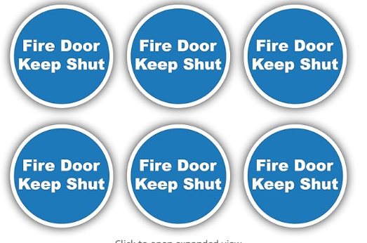 Six blue circular signs with white text "Fire Door Keep Shut."
