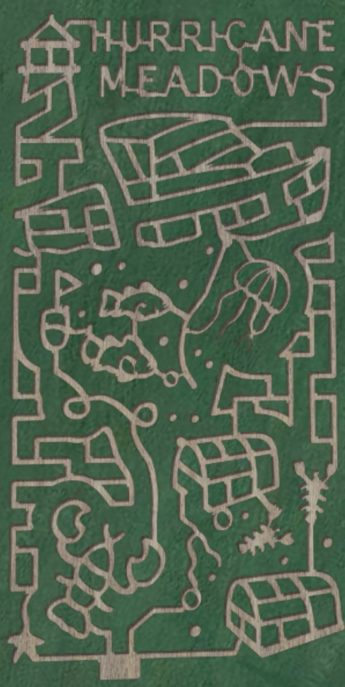 Laser cut wood map of Thurricane Meadows featuring pathways, a house, a boat, a skull, a tree, and a Christmas tree on a green background.