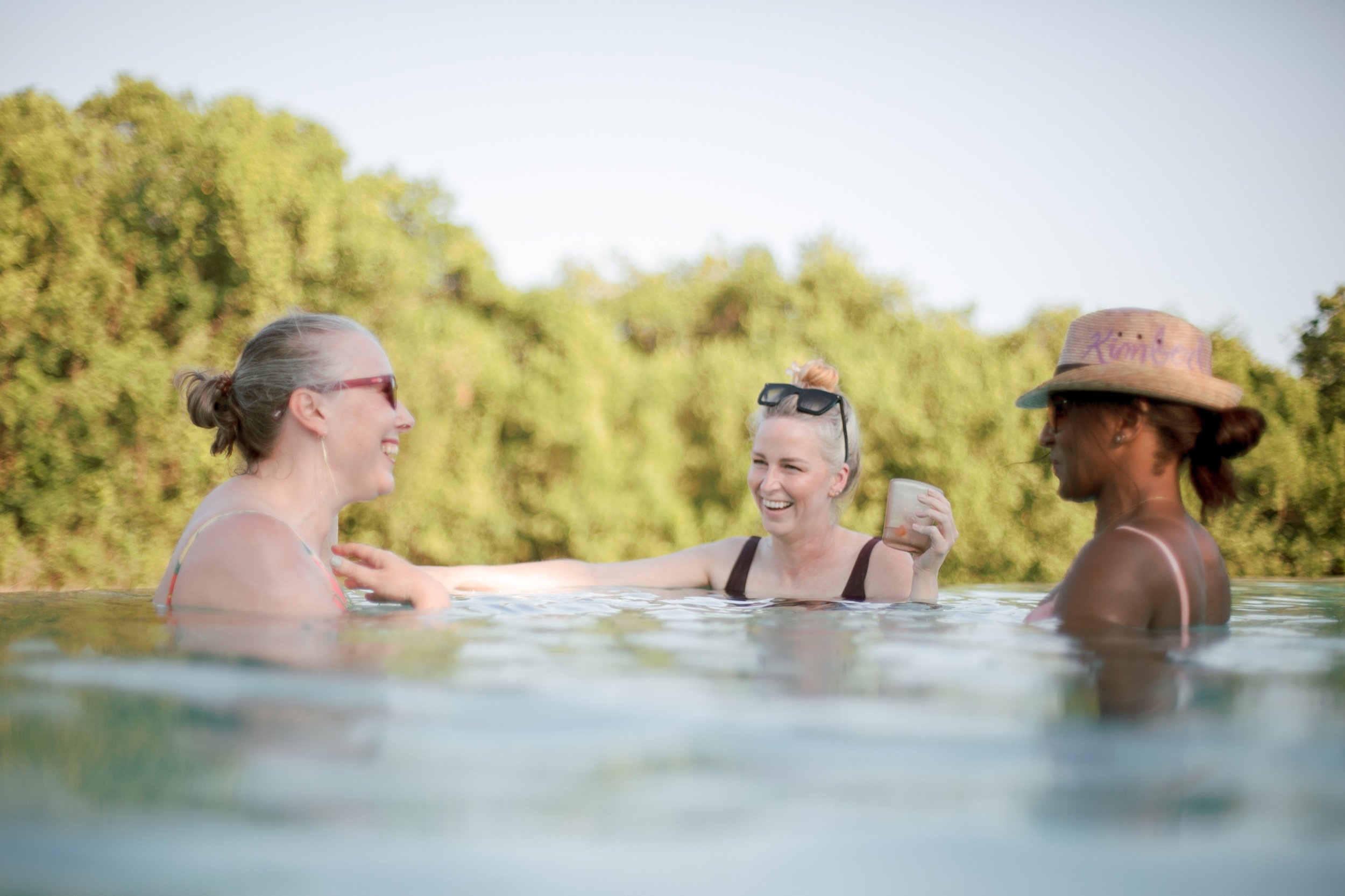 Guests relaxing in the pool at a wedding in Tulum.