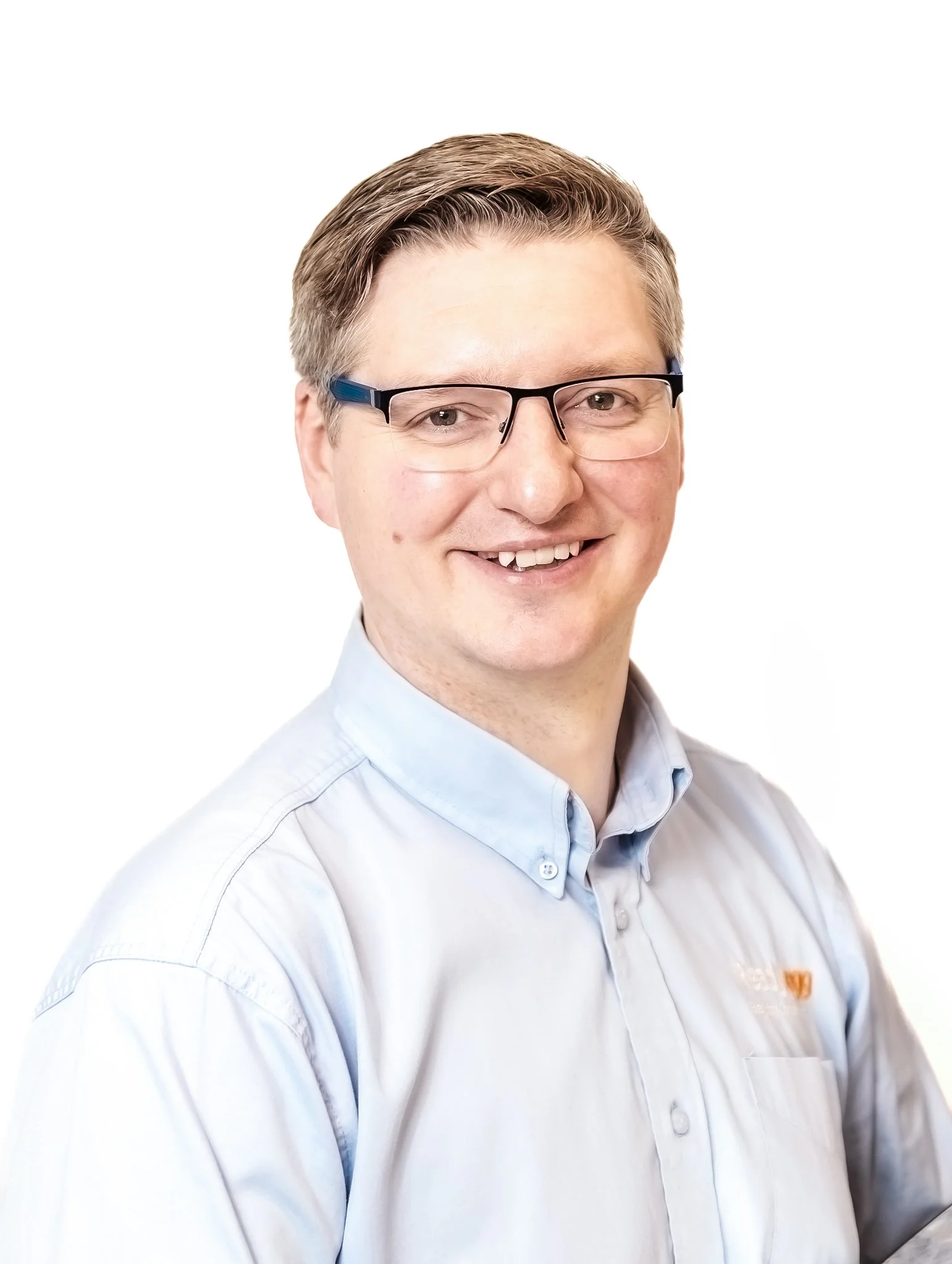 Smiling person with glasses in a light blue shirt