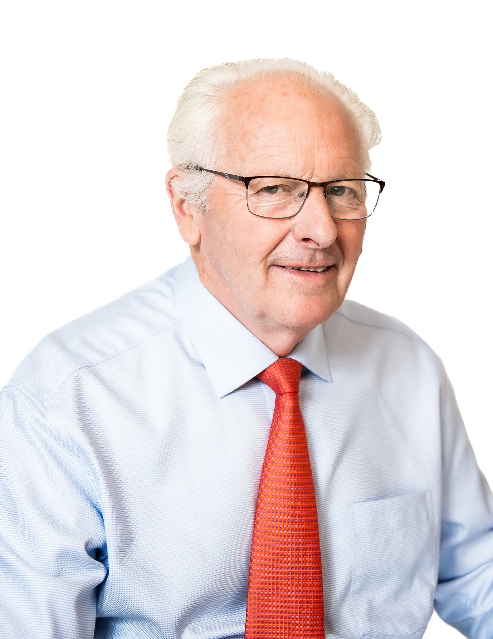 Elderly man wearing glasses, a blue shirt, and an orange tie against a white background.