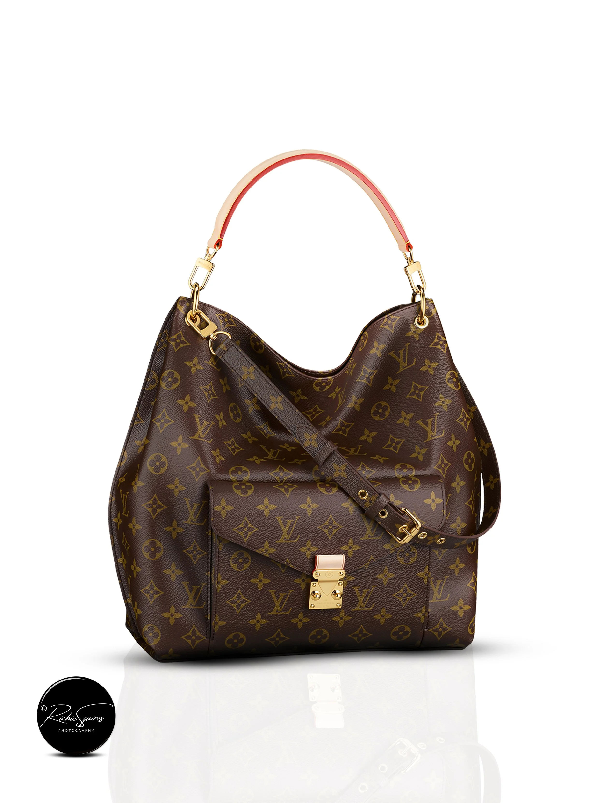 Luxury handbag with monogram pattern, gold hardware, and a single top handle.