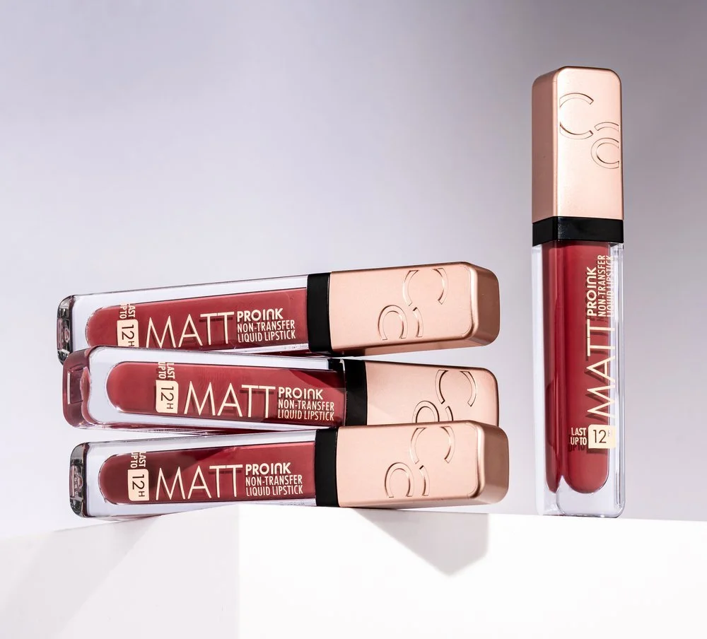 Four tubes of matte liquid lipstick labeled "Pro Ink Non-Transfer" with rose gold caps, arranged on a white surface.