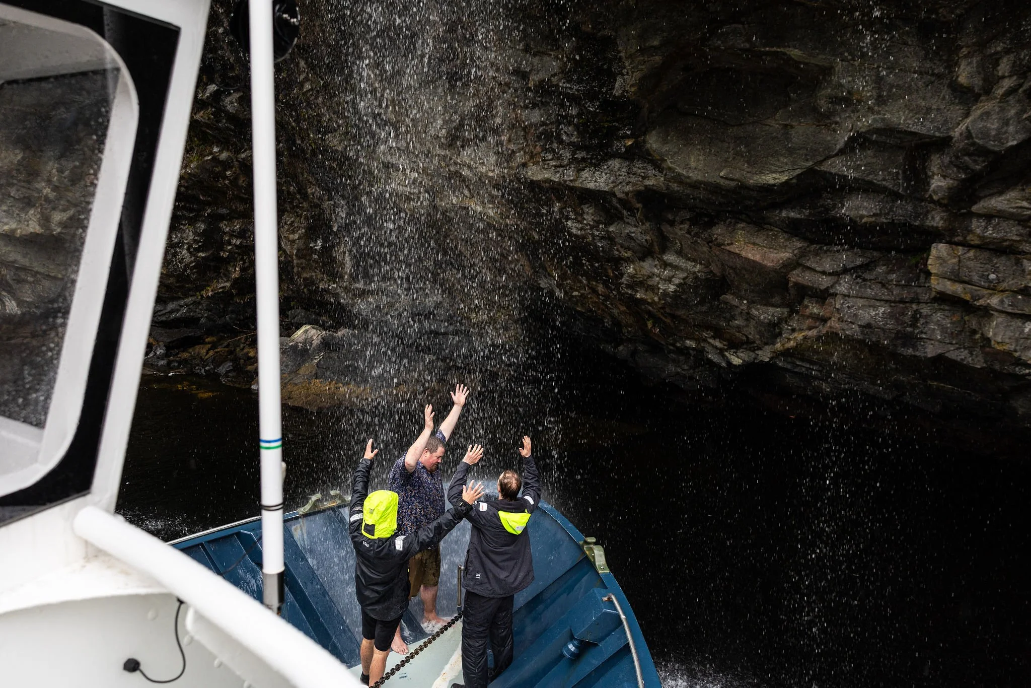 fiordland-expeditions-guest-arms-raised-waterfall-shower-doubtful-sound-c10313.jpg