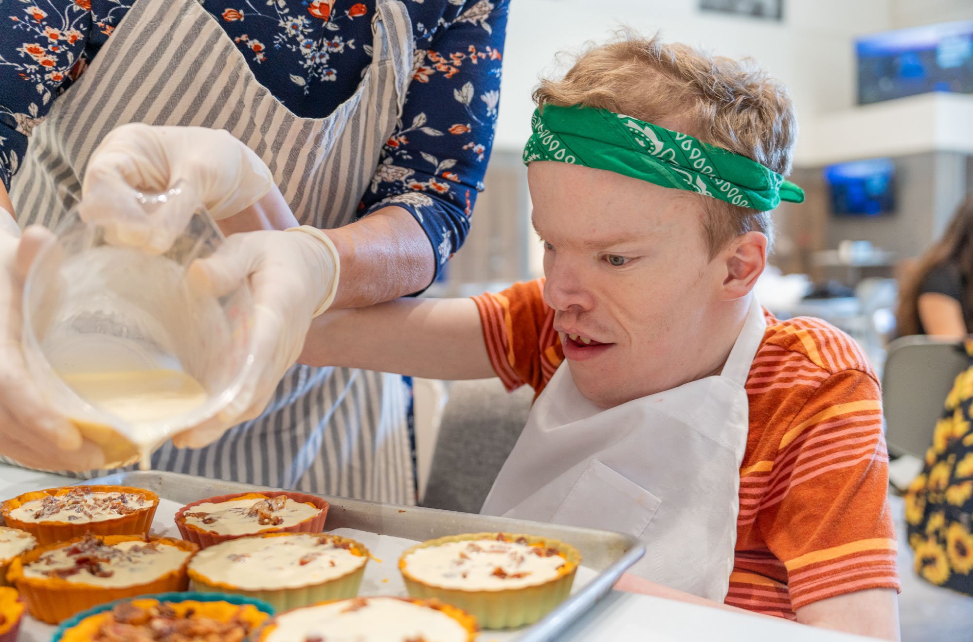 Man-with-green-bandana-preparing-mini-egg-bacon-quiches.jpg