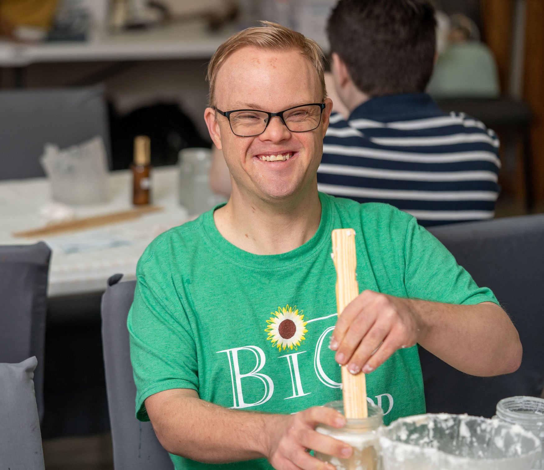 Man-with-glasses-and-green-shirt-making-custom-candles.jpg