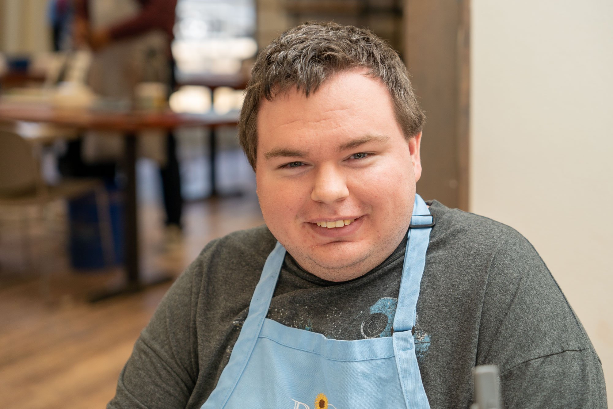 Young-man-with-Blue-Apron-Smiling.jpg