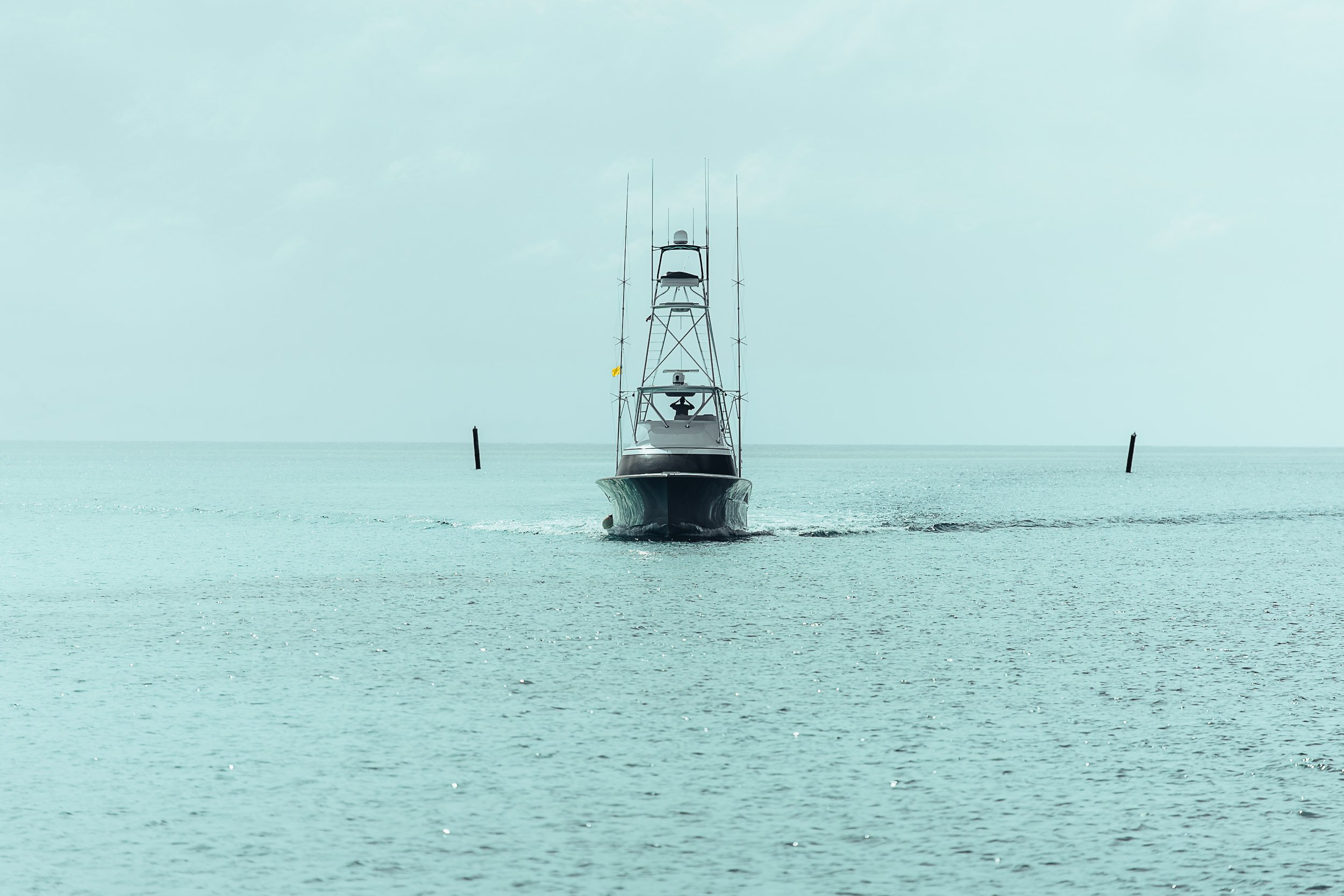 A motorboat traveling on calm water in the ocean.