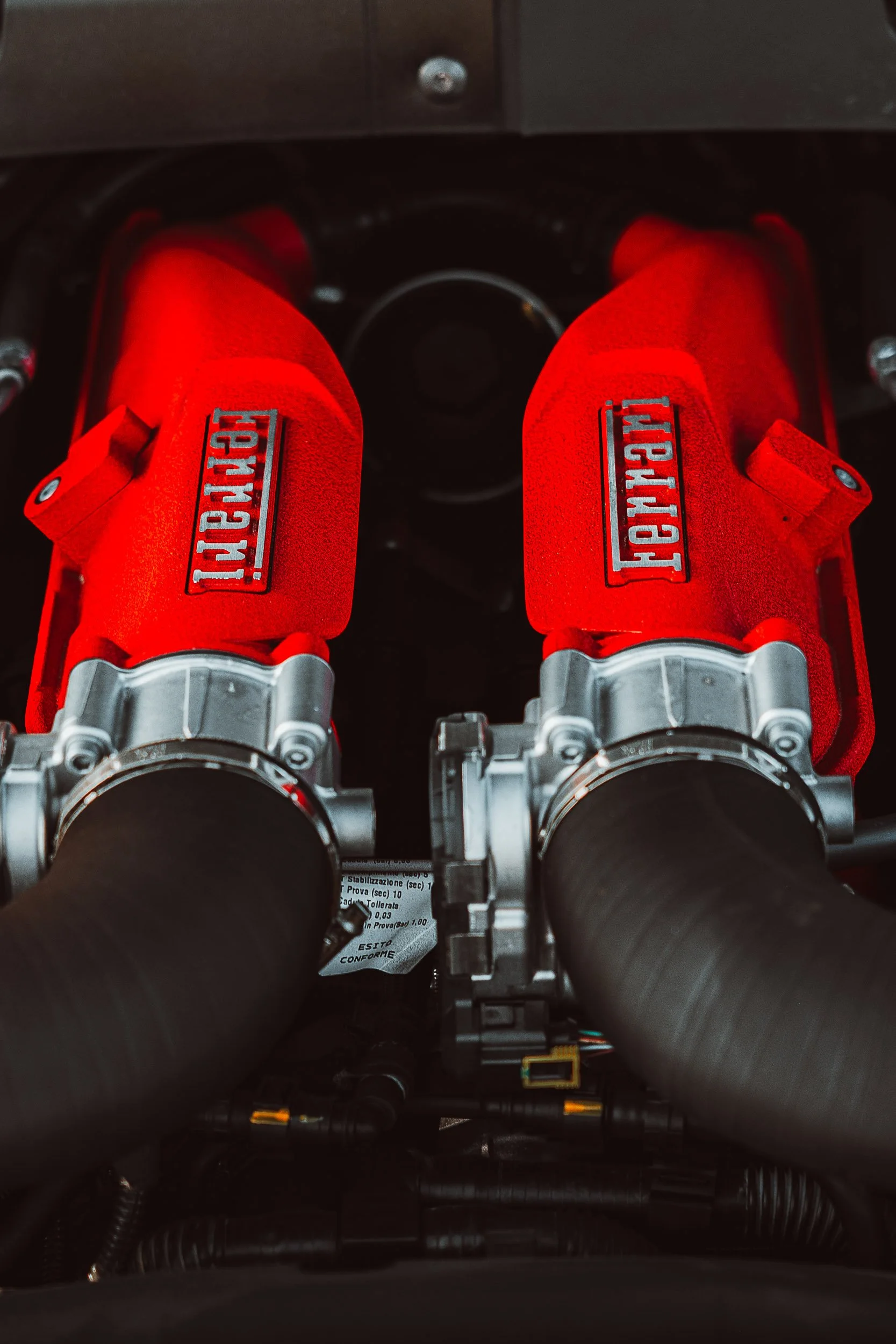 Ferrari V8 engine with red intake covers.