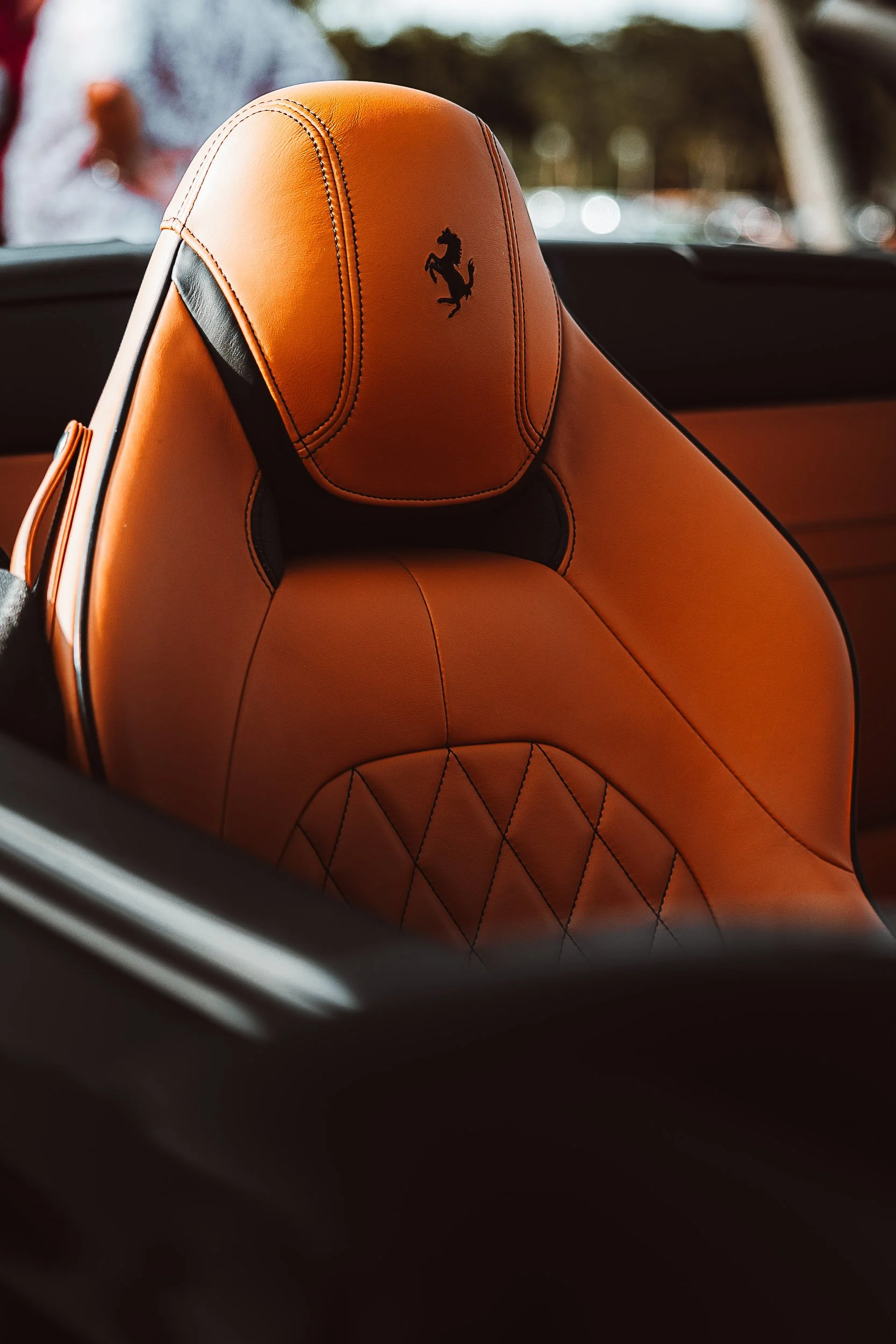 Luxury car seat with orange leather and logo