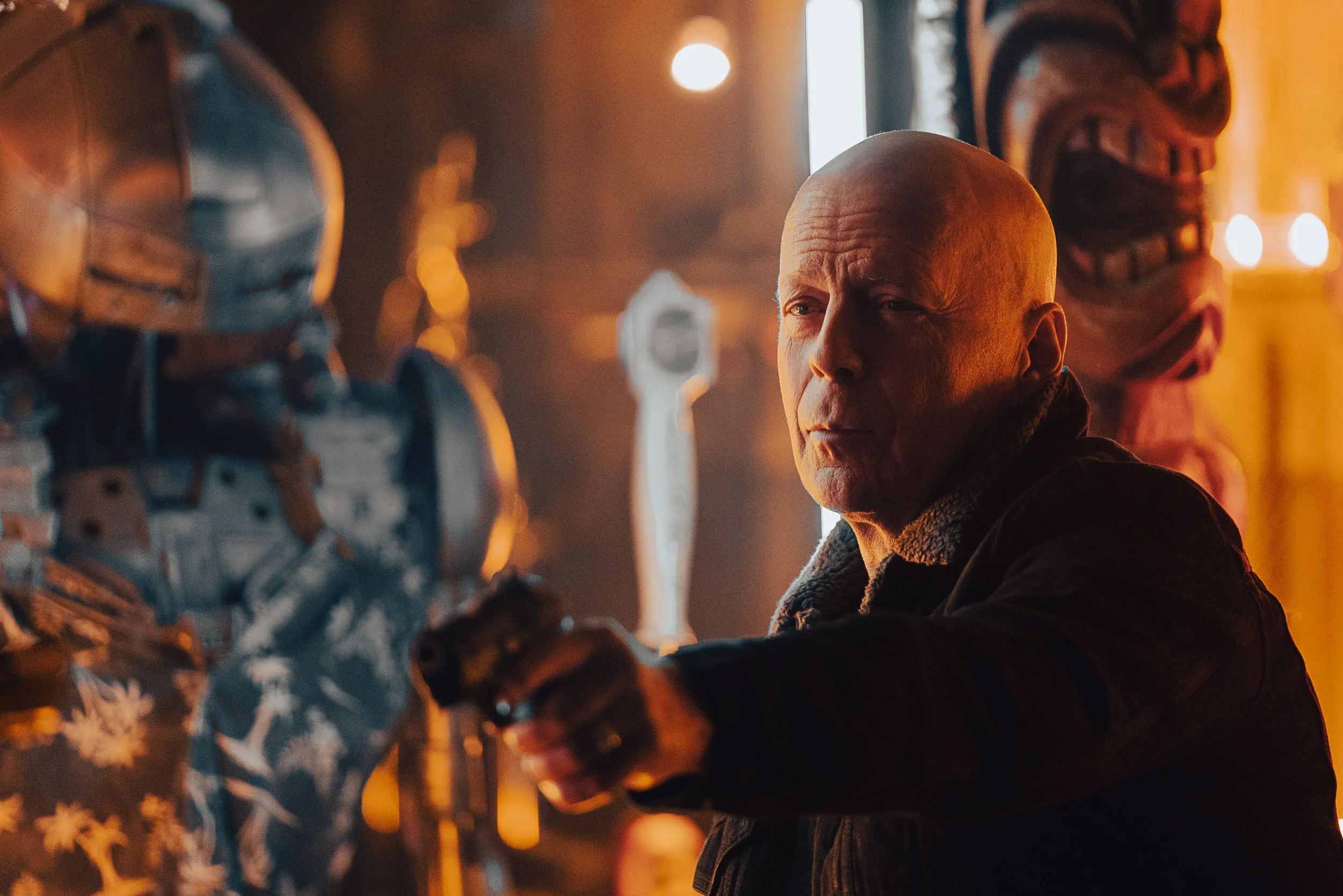 Person holding a gun in a dimly lit room with a futuristic or robotic theme.
