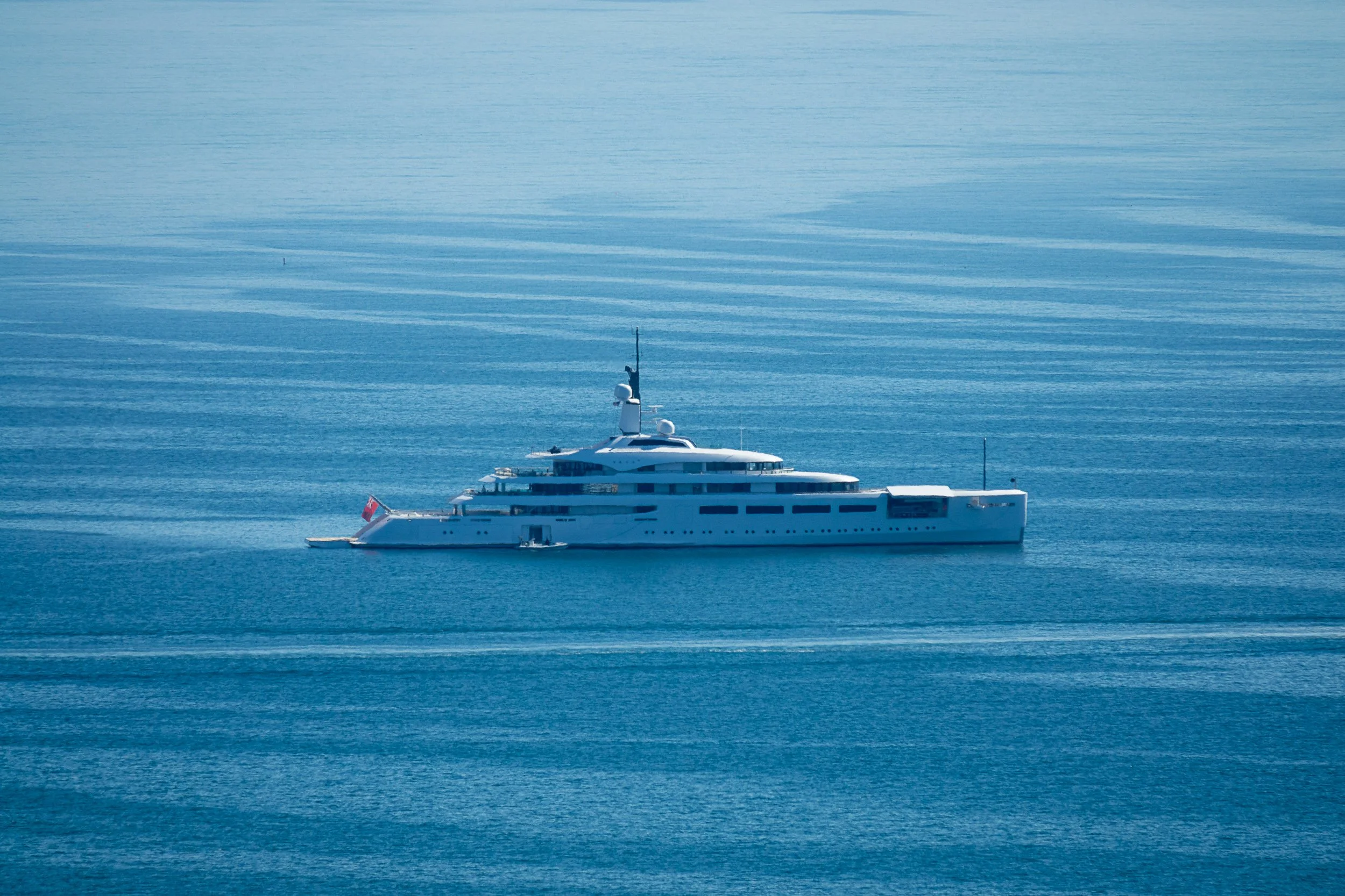 Luxury yacht sailing on a calm blue sea