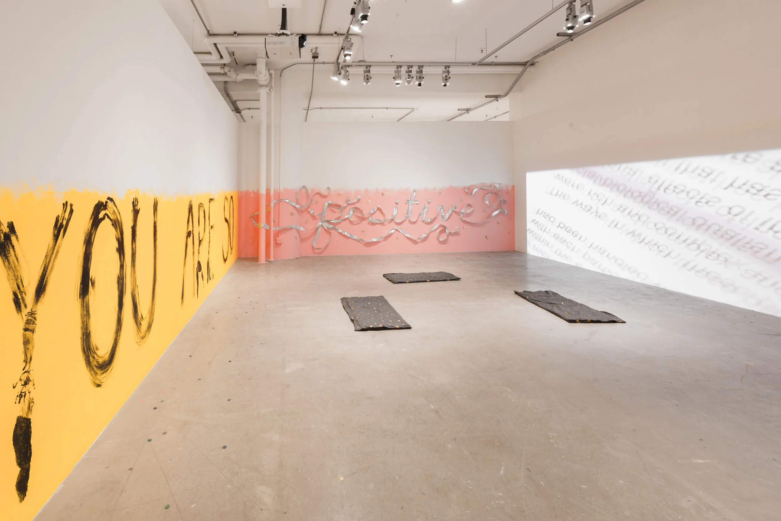 "Dis-empowered"; Installation; Sullivan Galleries (SAIC); Winter 2019; Image Description: A room in an art gallery is transformed into an interactive art installation. One wall is painted yellow halfway up the wall with the words "you are so" painted
