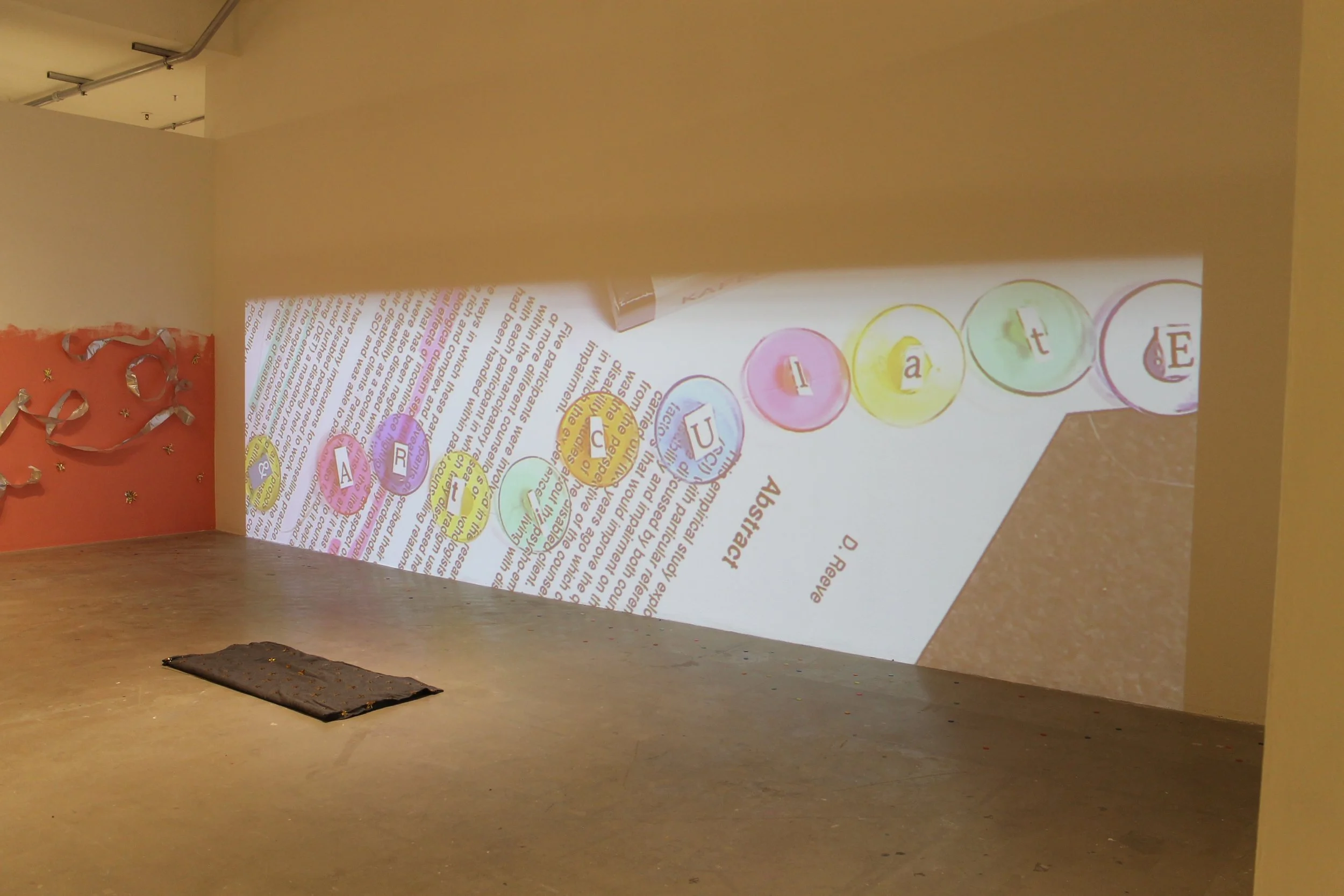"Dis-empowered"; Installation; Sullivan Galleries (SAIC); Winter 2019; Image Description: A room in an art gallery is transformed into an interactive art installation.  This is a photo of one of the walls where a video is being projected. This video 