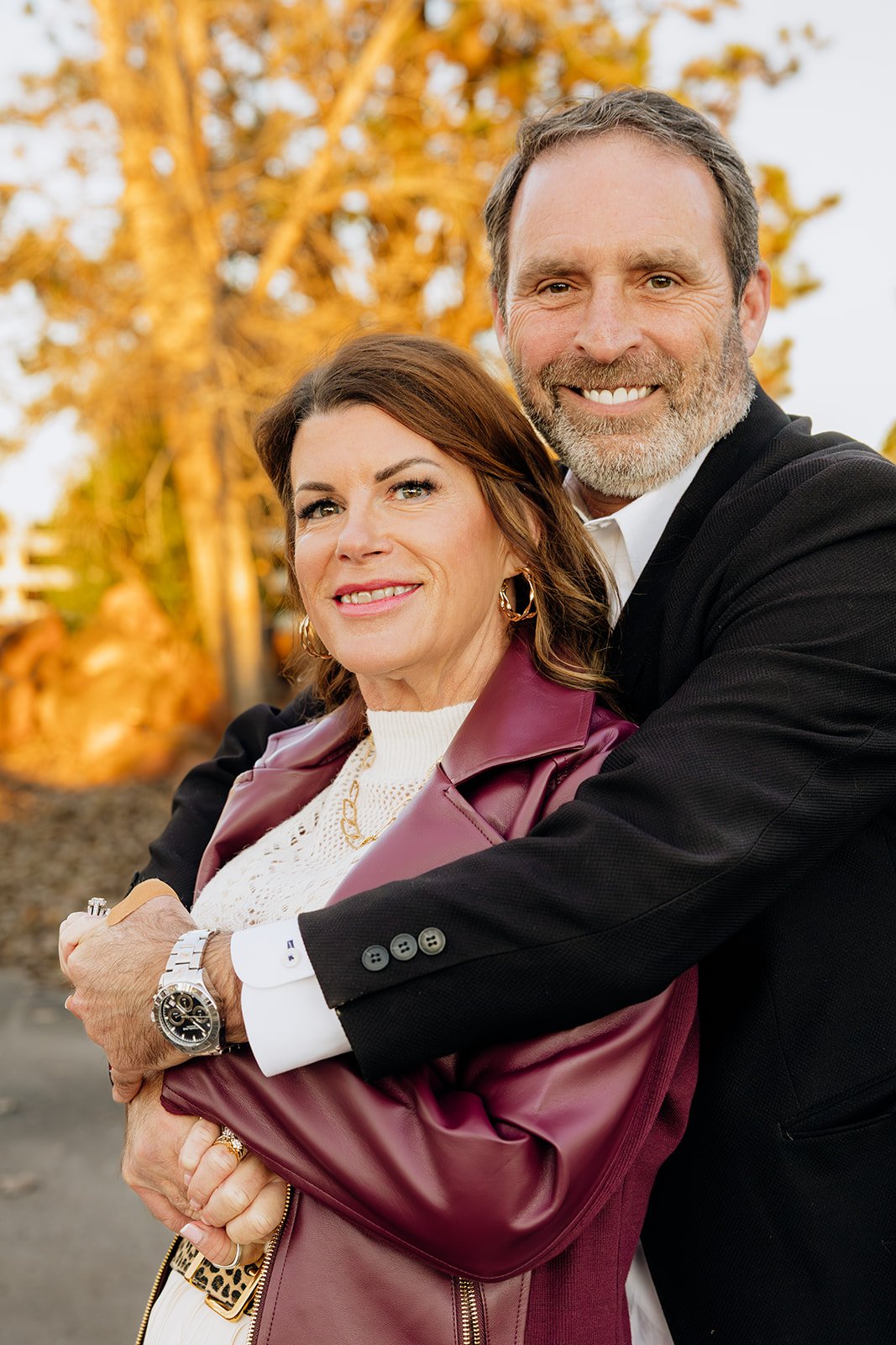 Mom and dad embracing in golden hour light during a fall mini session near Oklahoma City
