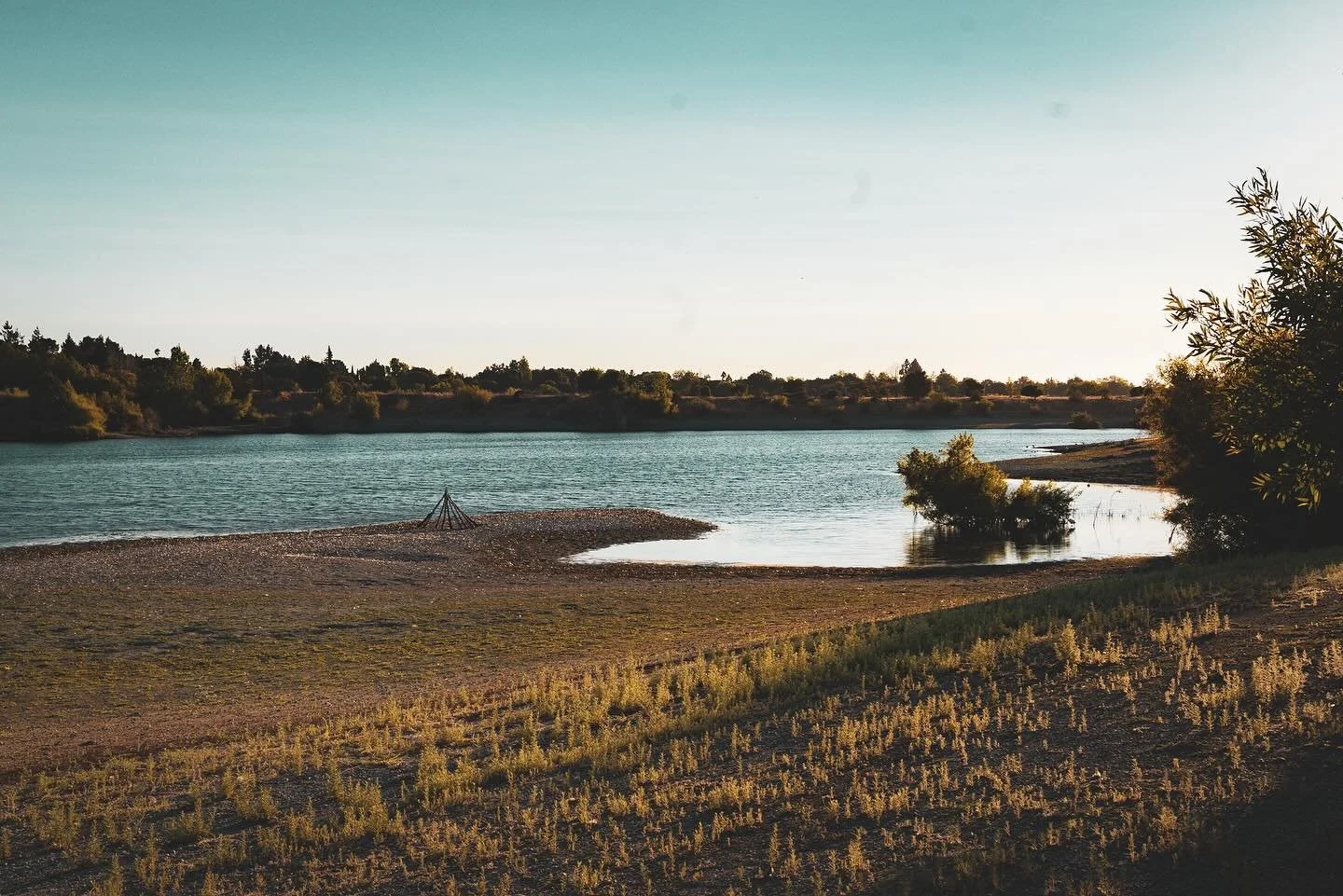 Evening light along the trails of Quarry Lakes, Fremont &mdash; where water meets the hills and time seems to slow. The air carries a soft stillness, the kind that makes you notice the simple grace of light on water and the quiet pulse of the earth b