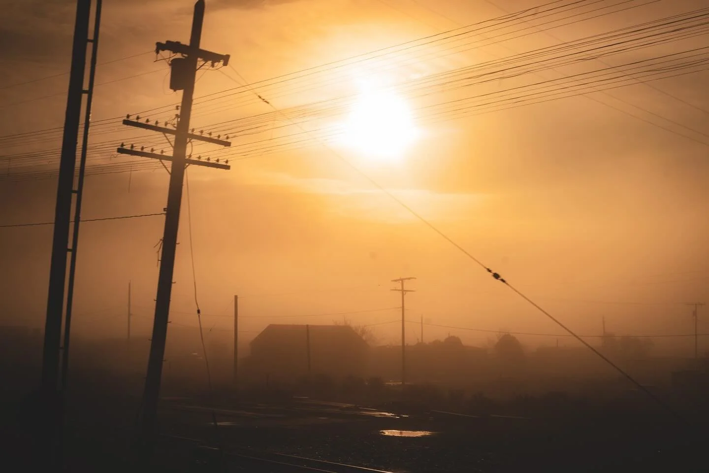 Sunrise over the Nevada desert, seen from a fast-moving train. The world was half-asleep &mdash; just silhouettes, wires, and light spilling through the fog. Everything felt both infinite and fleeting, like watching the soul of morning awaken for the