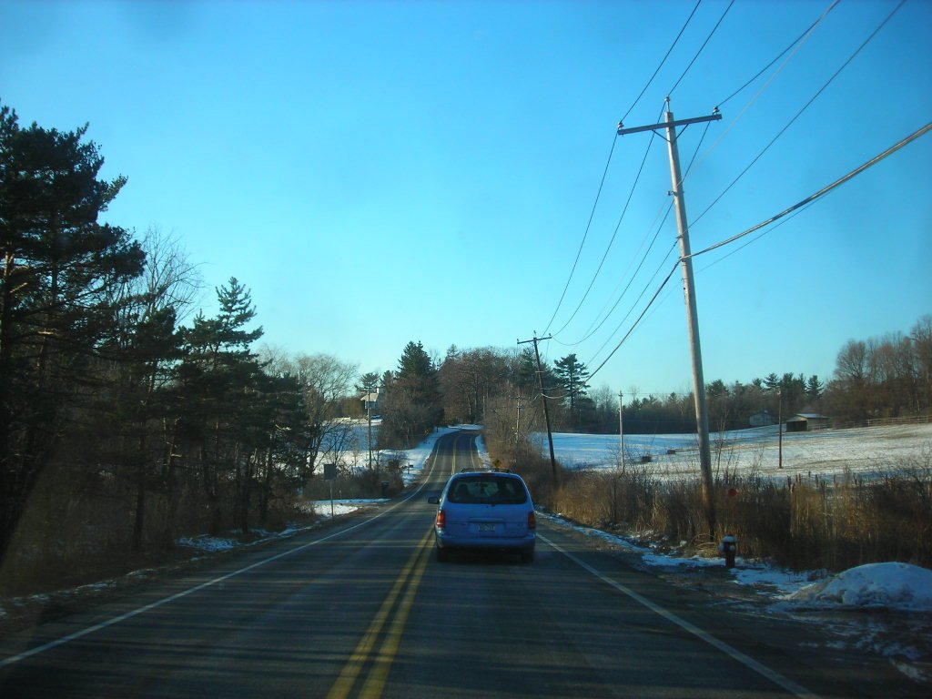 colonie new york in winter with road and minivan