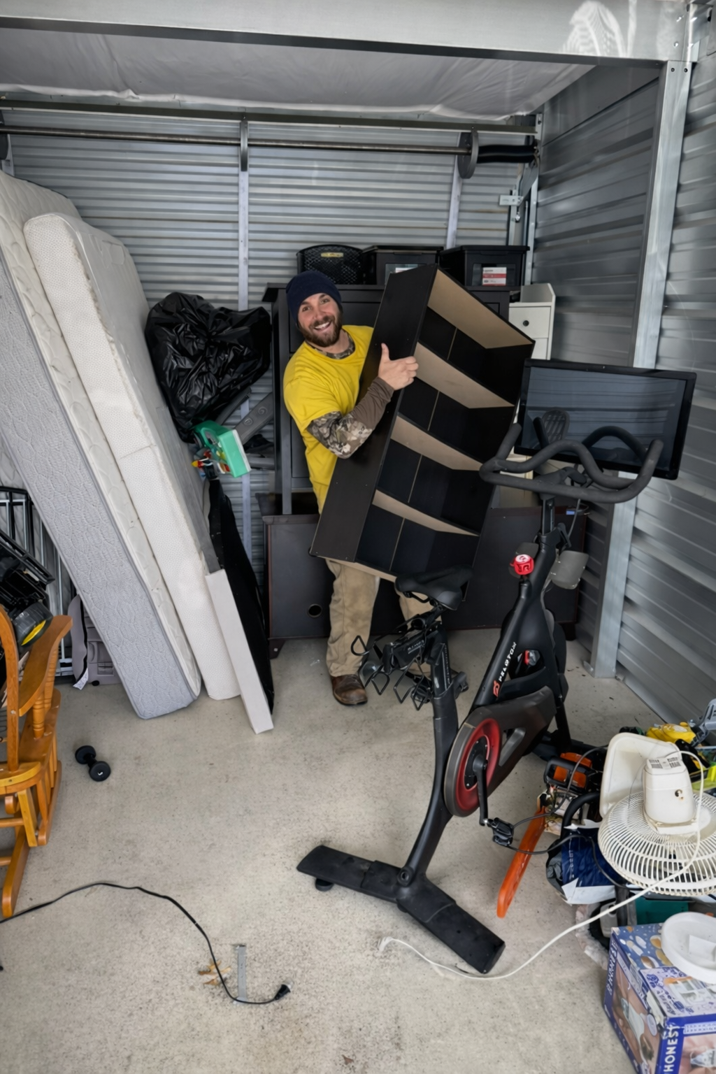 four men unloading in truck, movers in moving truck with yellow shirts