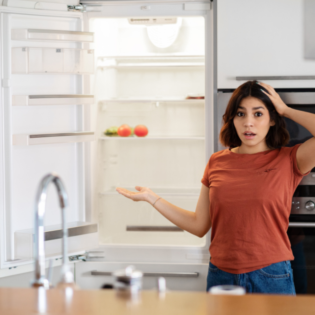 mum staring at an empty fridge