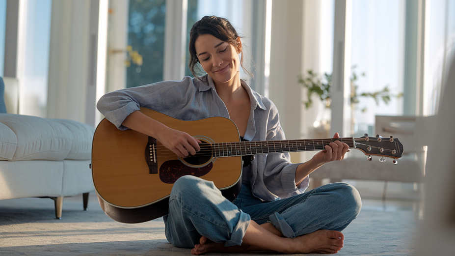 woman taking care of herself by playing the guitar