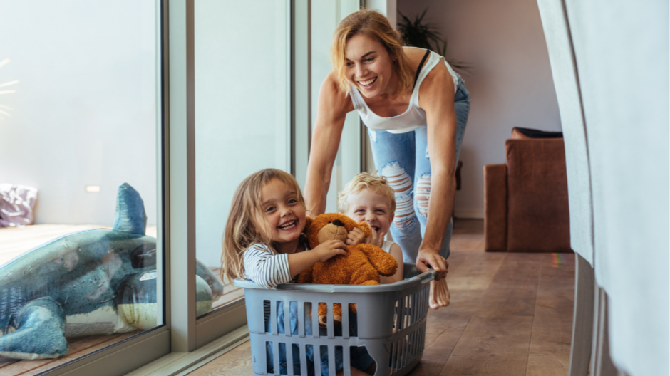 mother playing and laughing with children