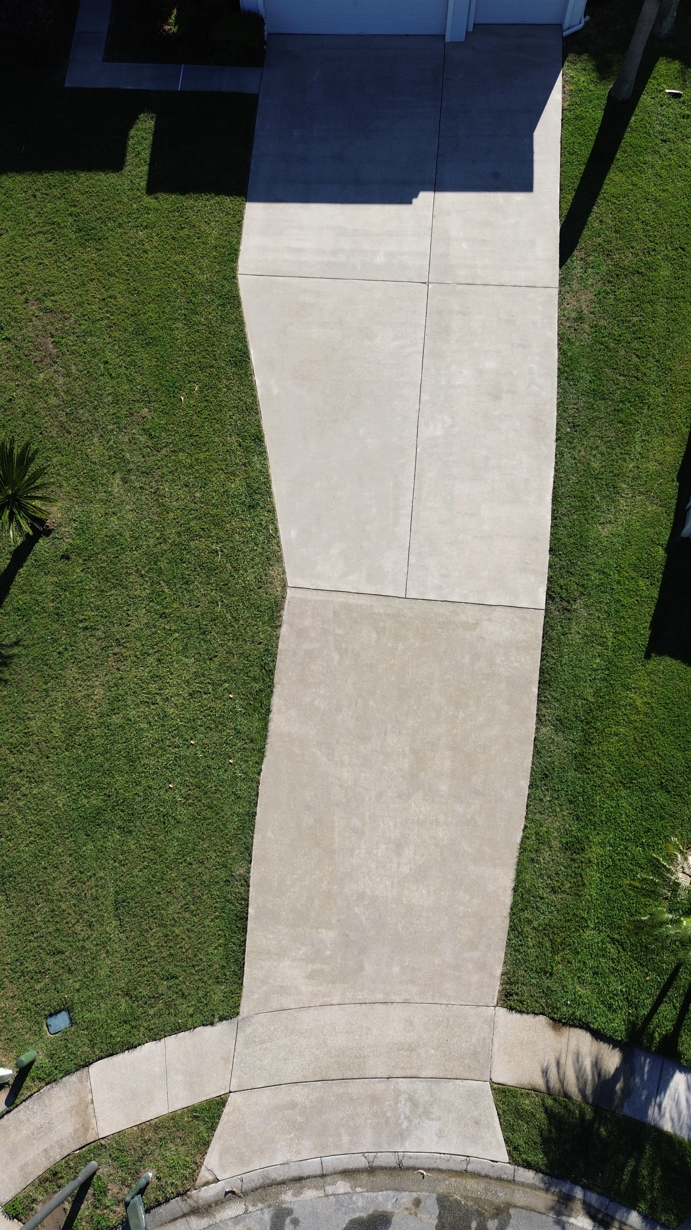 Clean driveway after pressure washing has been completed. Leaving a bright streak free surface.