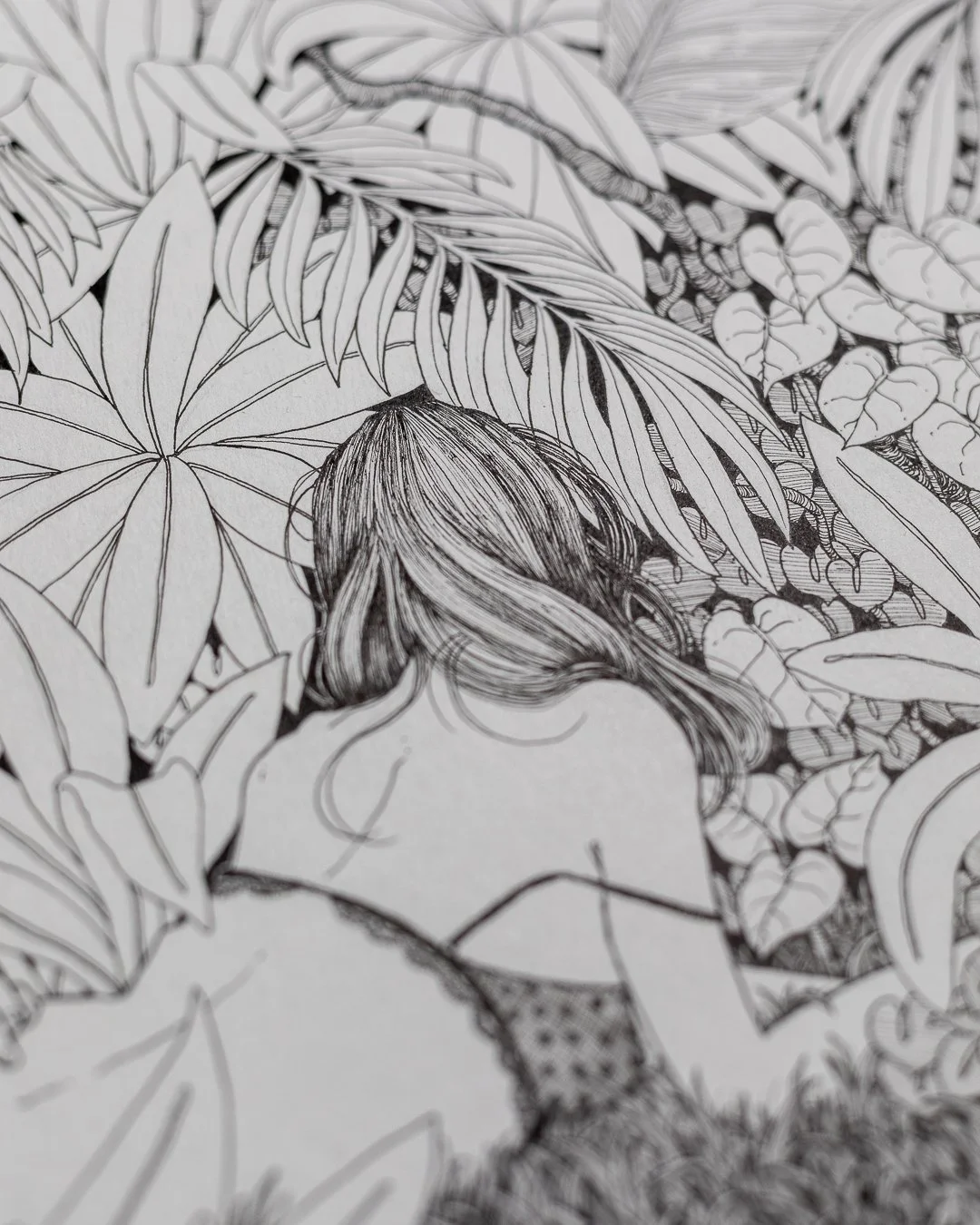 Black-and-white illustration of a woman with long hair, surrounded by dense tropical leaves and plants.