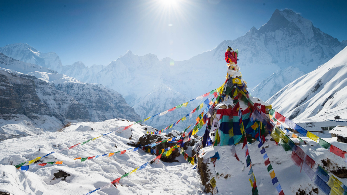 Beautiful view of Annapurna Base Camp with prayer flags in the foreground and Machhapuchhare and Gangapurna in the background.