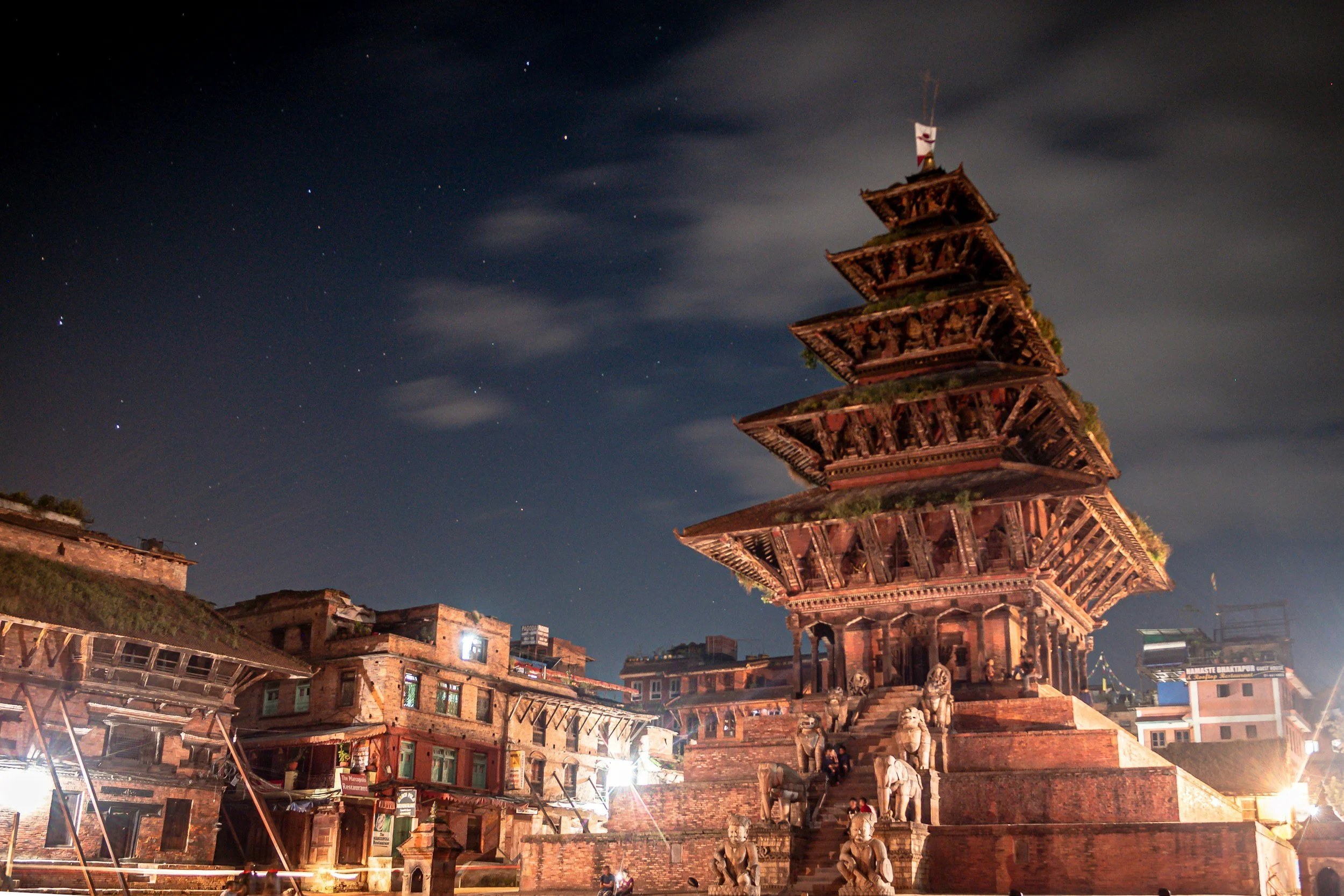 Bhaktapur Durbar Square at dusk, with the Nyatapola Temple rising against a deep blue evening sky.