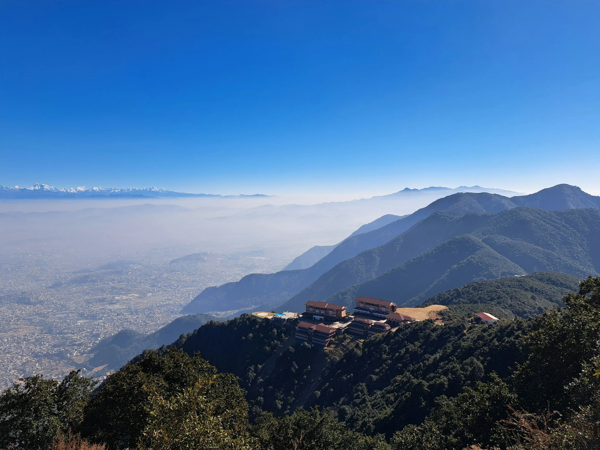 Chandragiri Hills overlooking the Kathmandu Valley, with Himalayan mountain ranges in the distance.