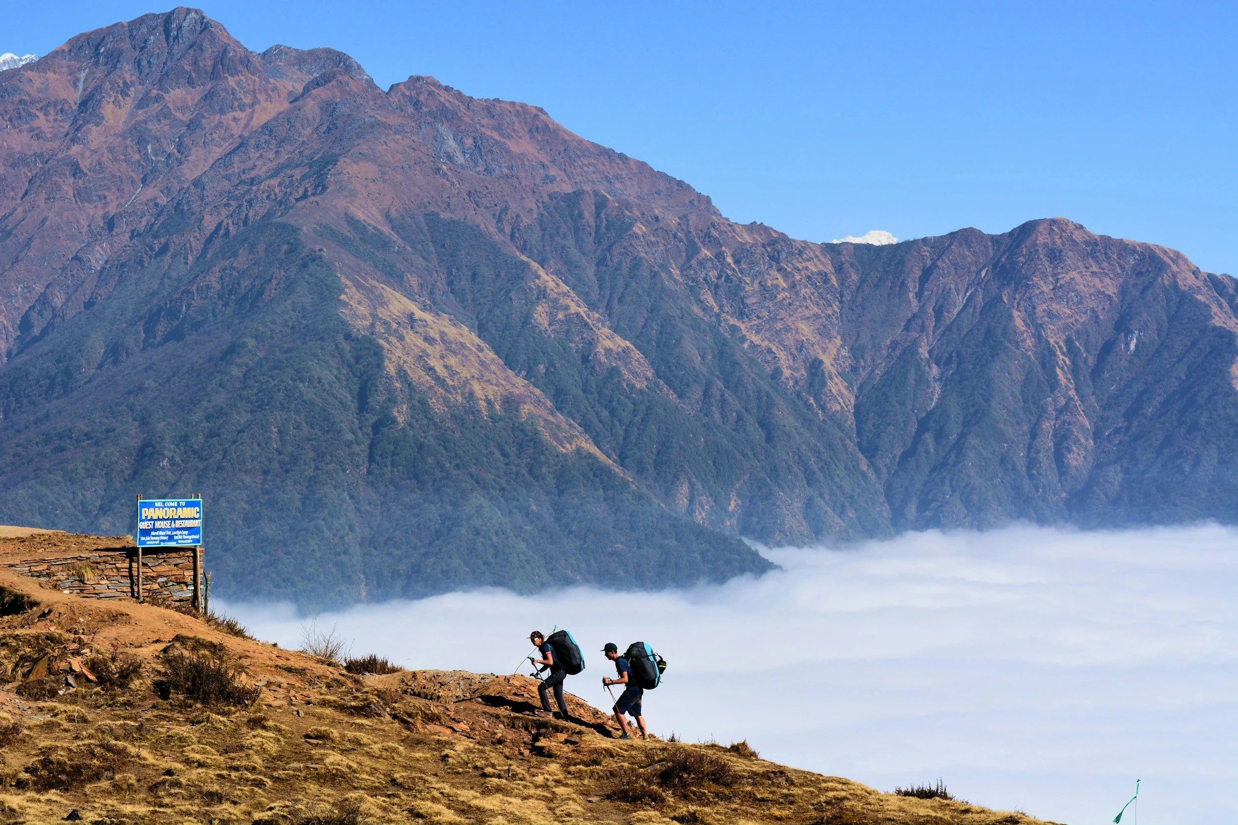 Beginner trekkers walking with a guide on an easy hiking trail in Nepal