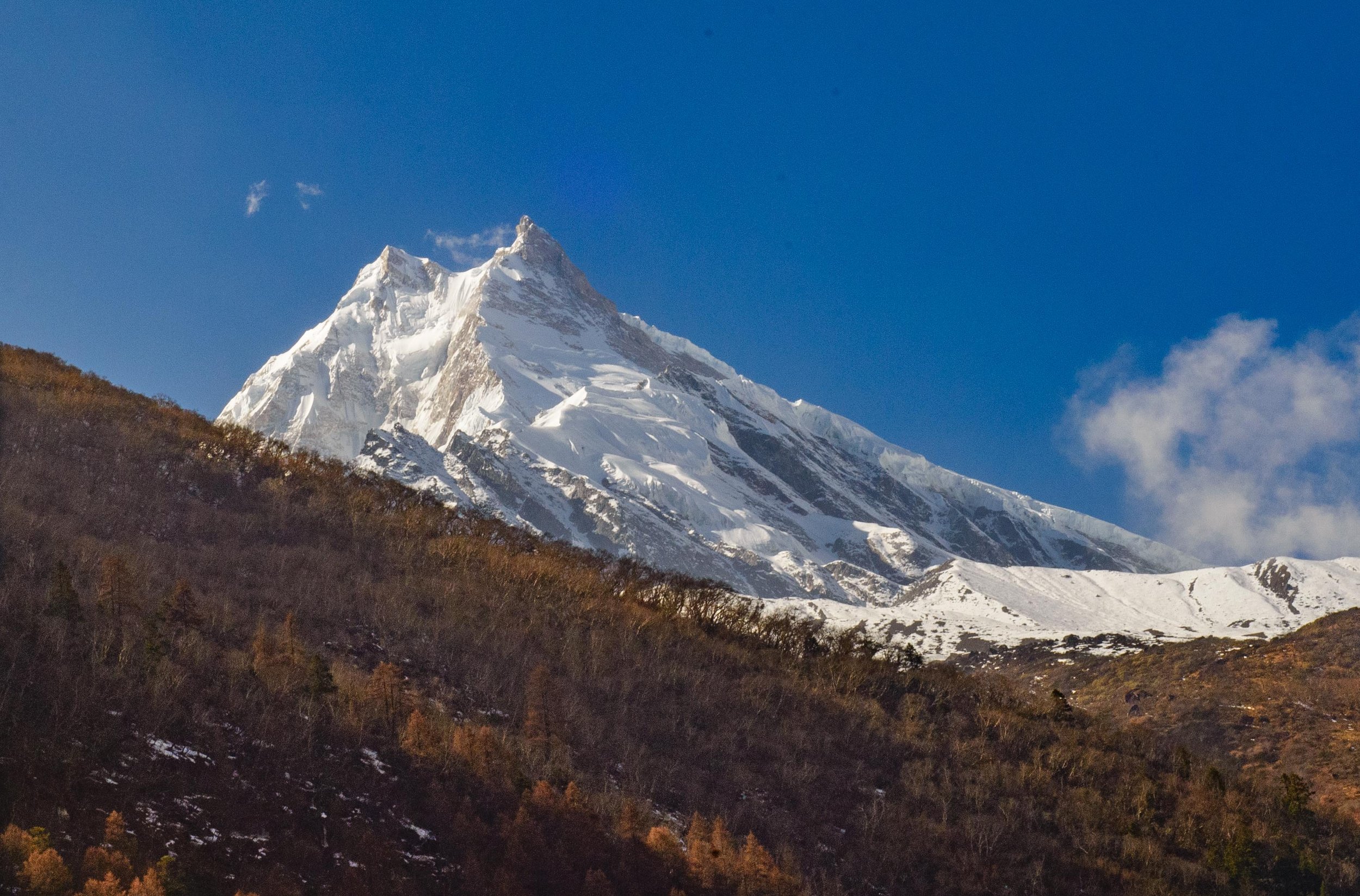 Manaslu rising straight up toward the sky, dominating the surrounding Himalayan landscape in Nepal.