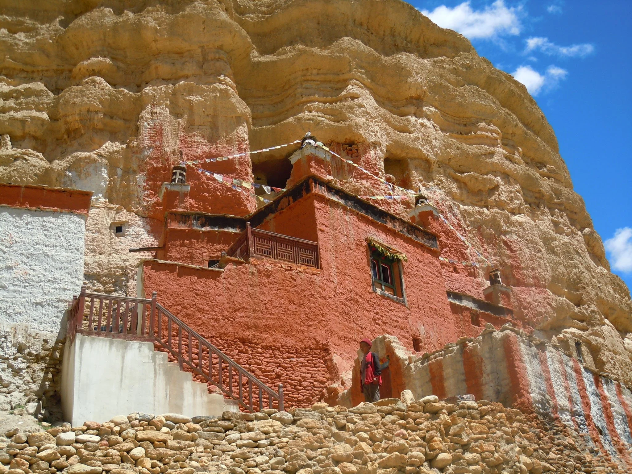 Mountain landscape in Upper Mustang with ancient caves carved into the rock and a monastery built in the surrounding cliffs.