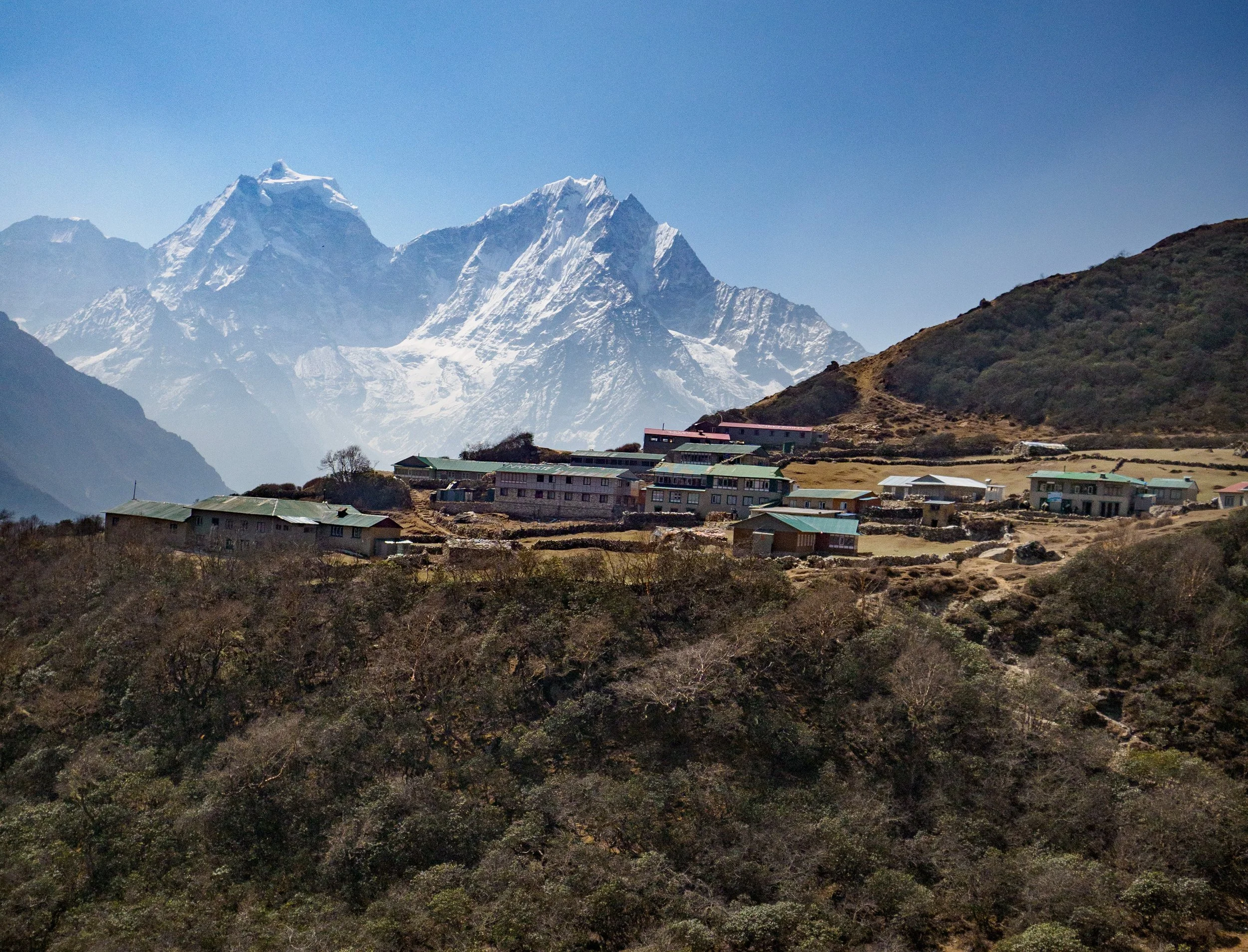 Mountain village with snow-covered peaks in the Himalayas