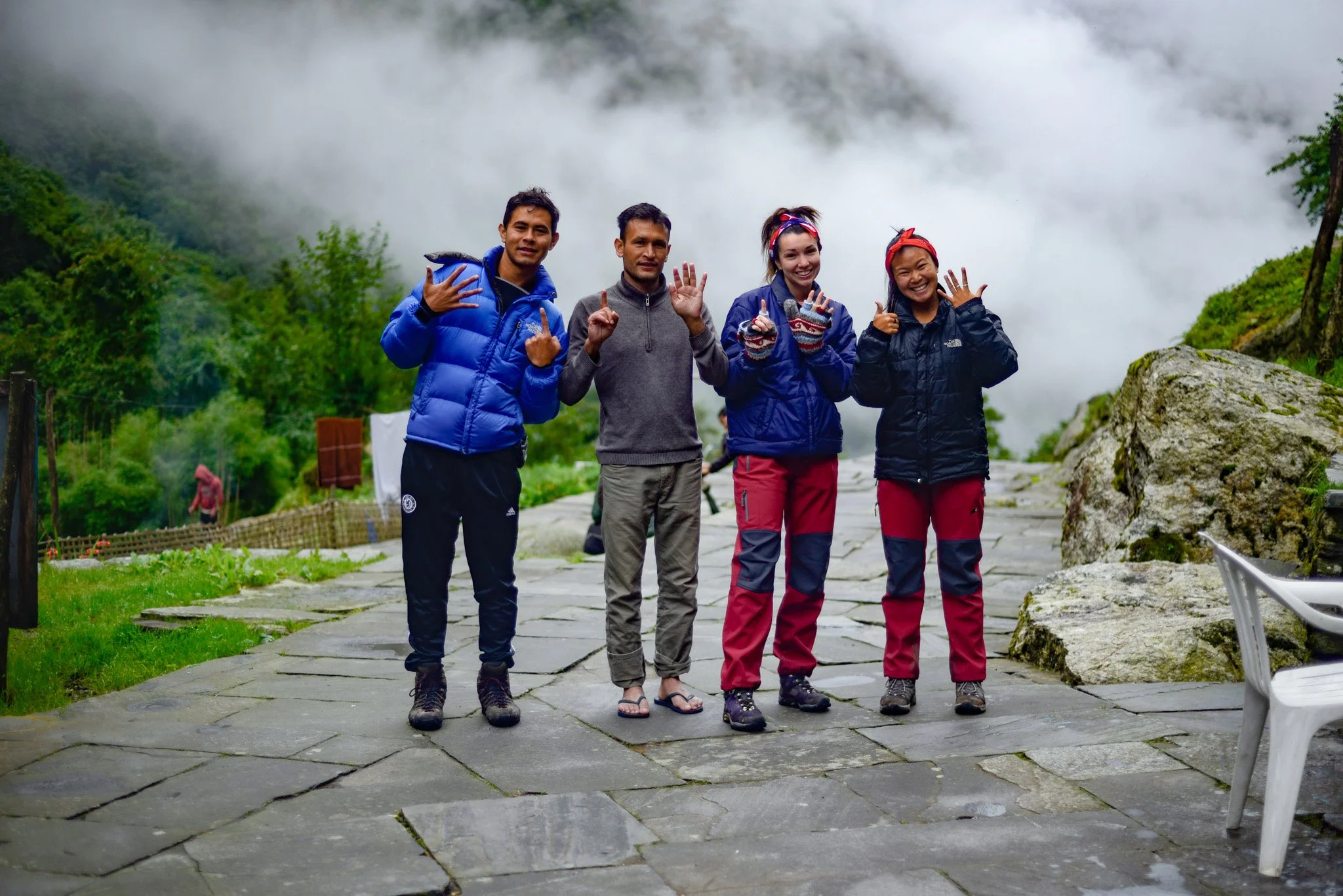 A trekking guide and guests posing together for a group photo on the trail.