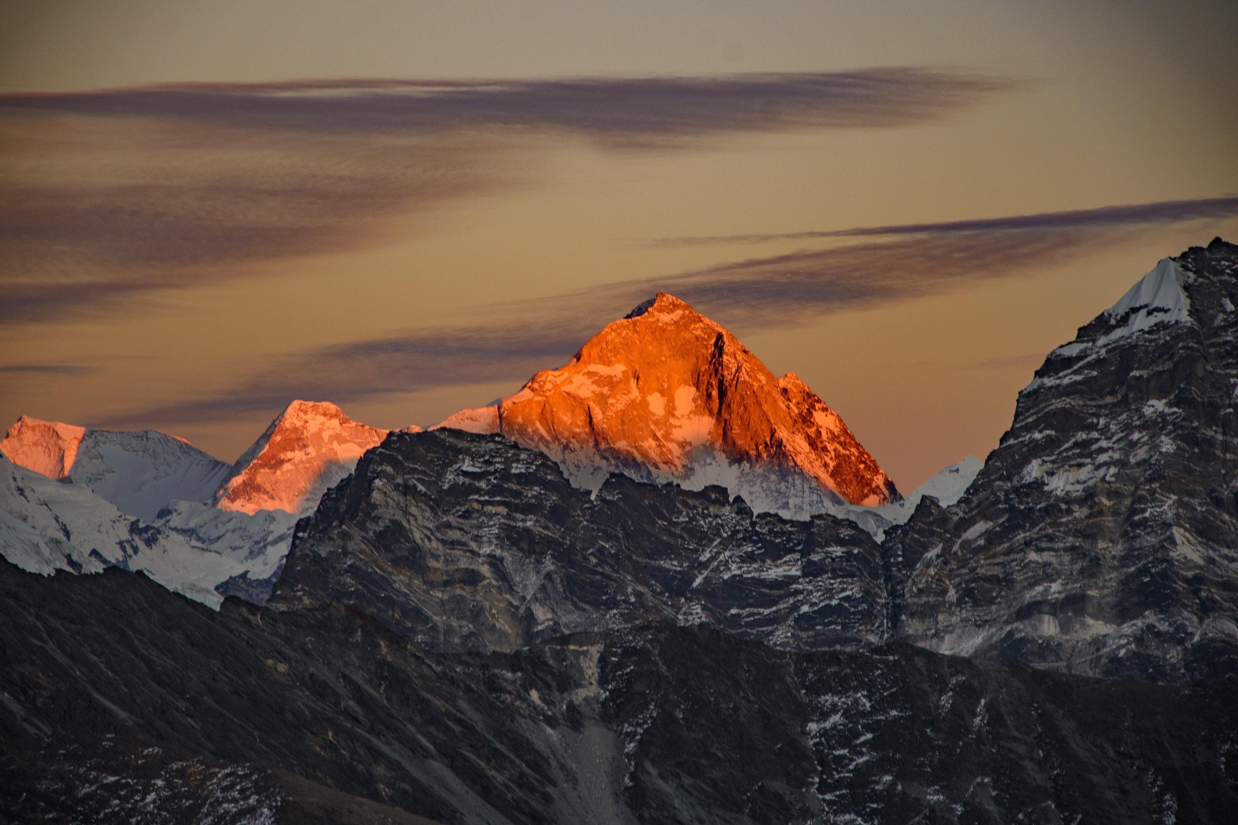 Makalu glowing bright red at sunset, with the rugged Himalayan peaks surrounding the mountain in eastern Nepal.