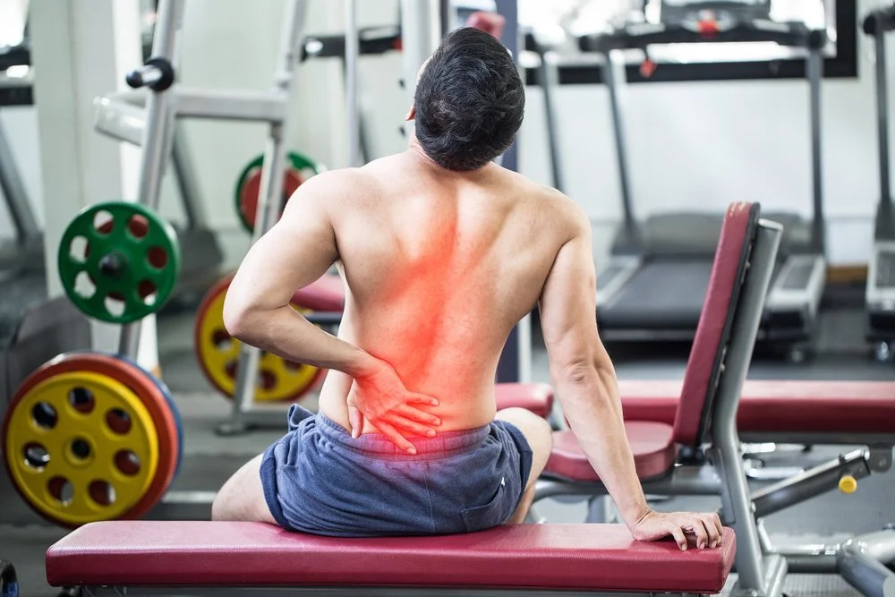 Why your back hurts after the Gym (and it’s not just because of deadlifts)
