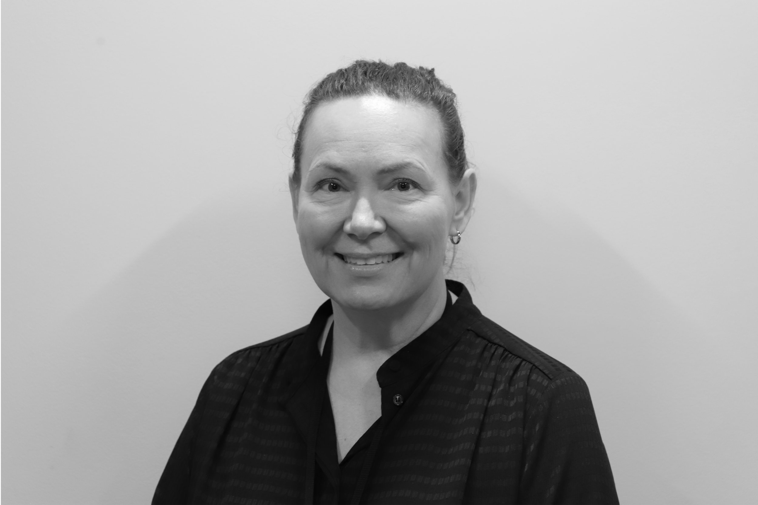Silhouette of a woman with medium-length hair against a light background.