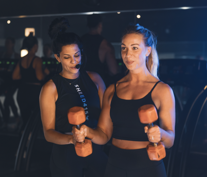 Two ladies lifting weights