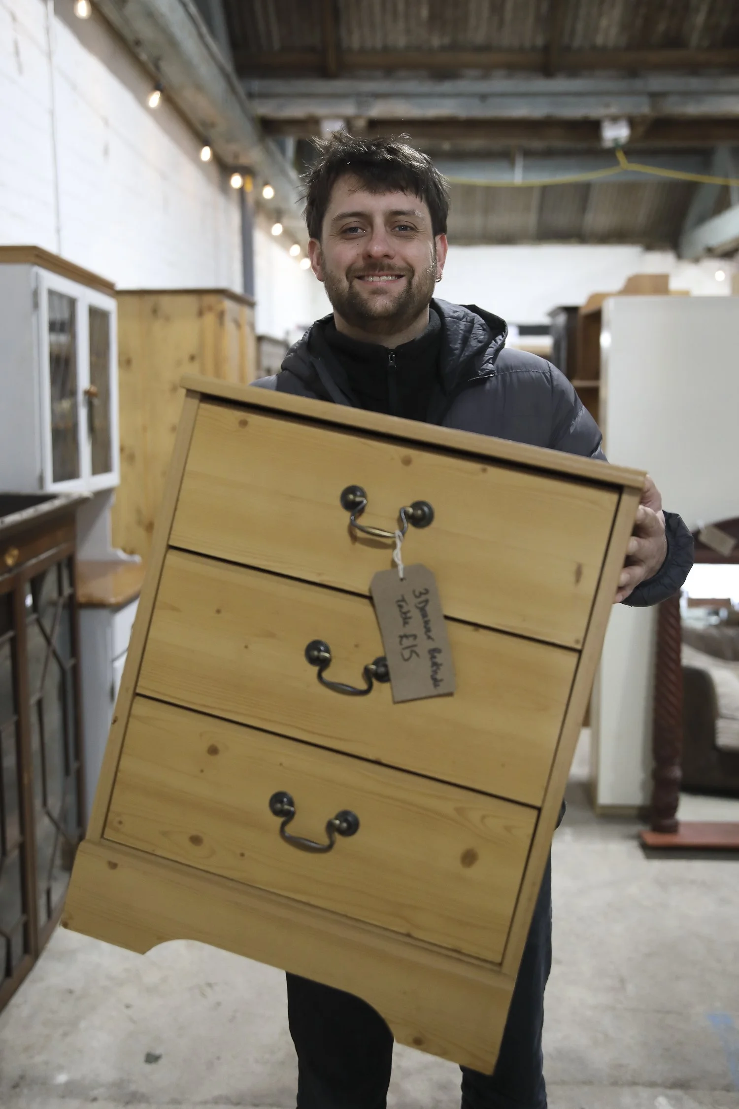 Chest of drawers being carried by man