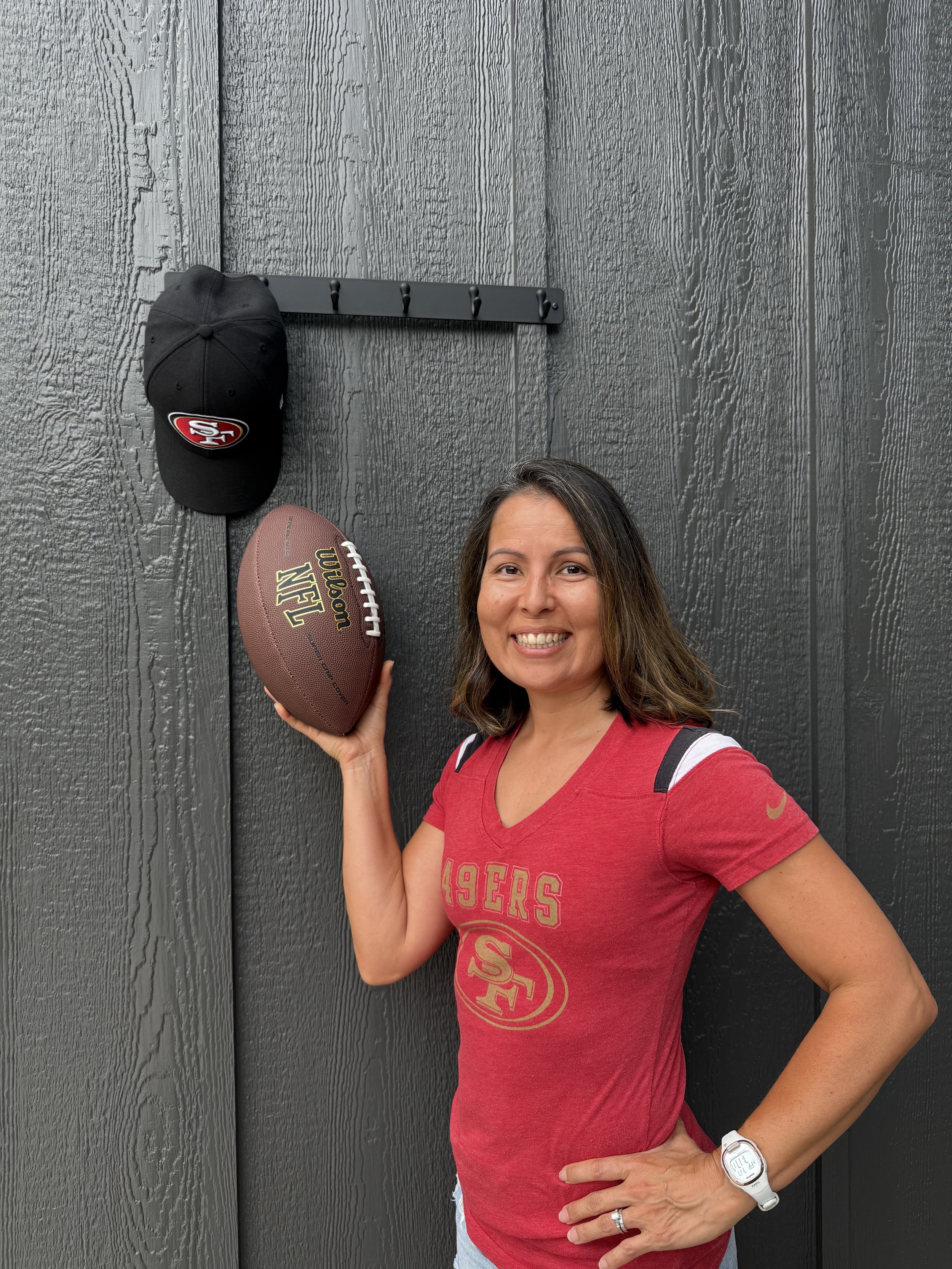 Indigenous Woman in 49ers T shirt Holding a Football