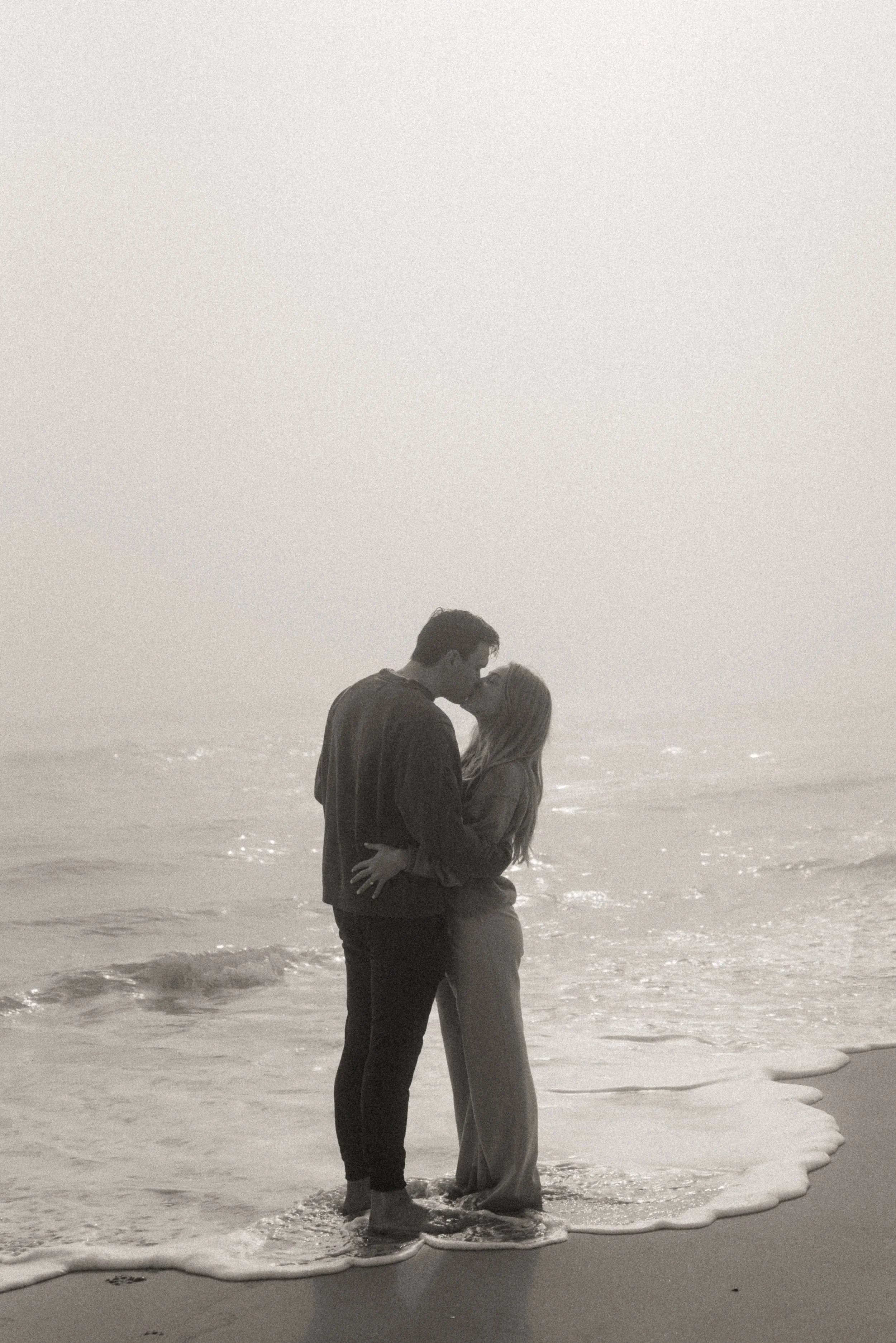 romantic couple kissing on the beach