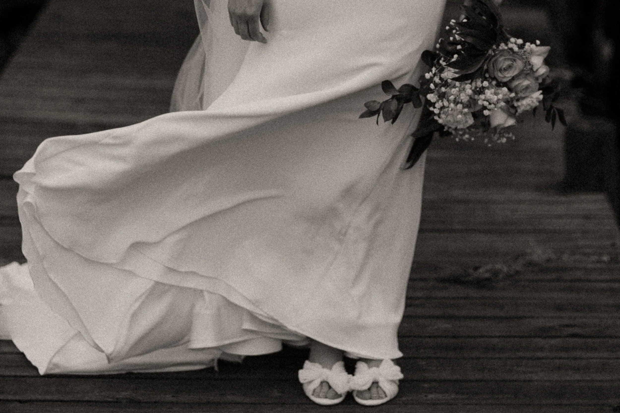 a bride's gown pictured blowing in the wind romantically, photographed artistically by one of the top wedding photographers in wilmington, nc