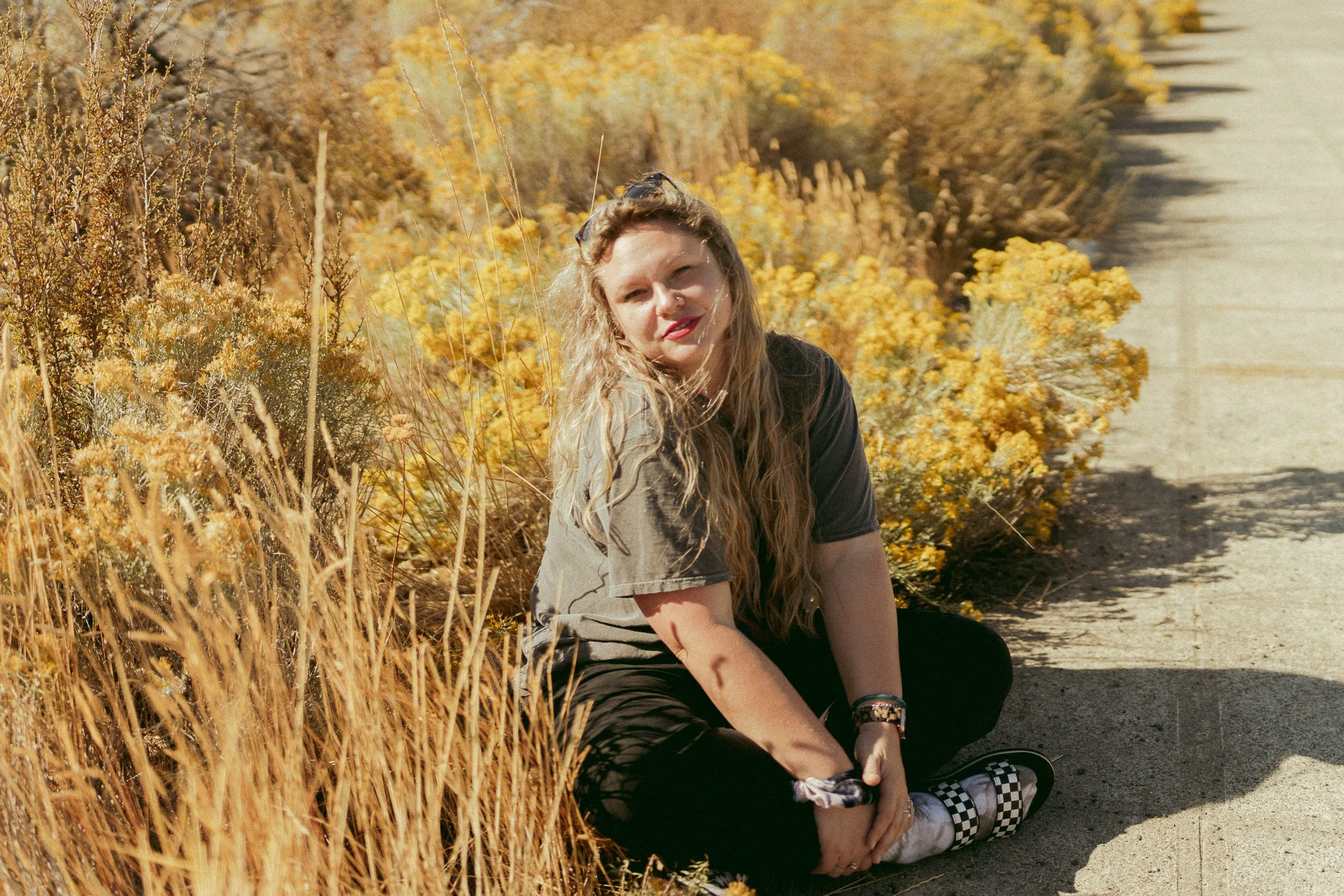 Ashley Seagle photographed in the wild terrain of Eastern Washington—sunlit hills, cowgirl edge, and the kind of soulful presence that belongs in every dream Yakima or Seattle elopement.