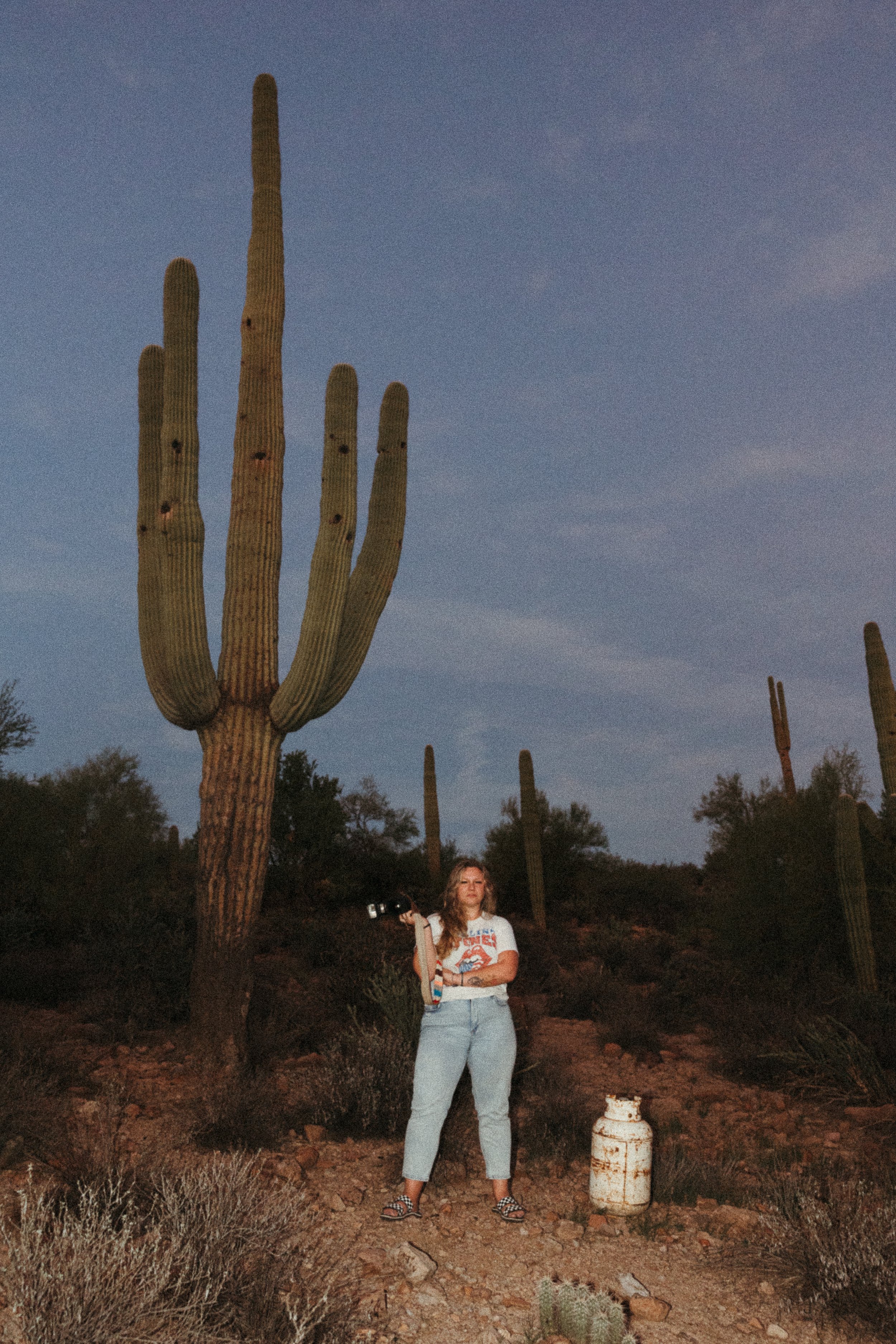 Arizona Wedding Photographer, Ashley Seagle, of Seagle Photography, standing beside a towering saguaro cactus in the Arizona desert near Scottsdale—capturing the spirit of the Southwest with editorial edge.