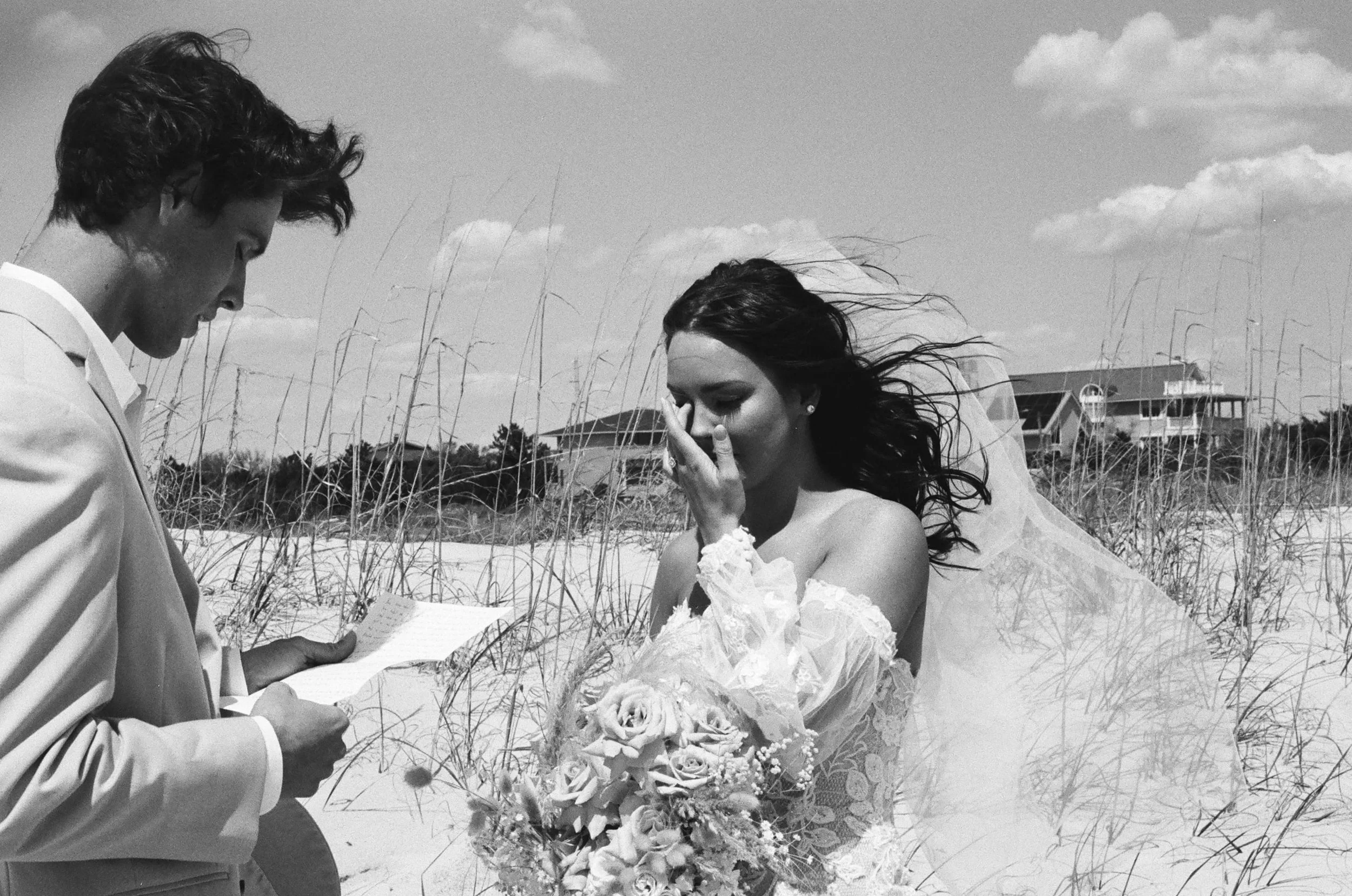 Grainy black and white Kodak film photo of intimate elopement ceremony out on the beach in the springtime at Wrightsville Beach in Wilmington North Carolina, photographed by Wrightsville Beach photographer, Seagle Photography