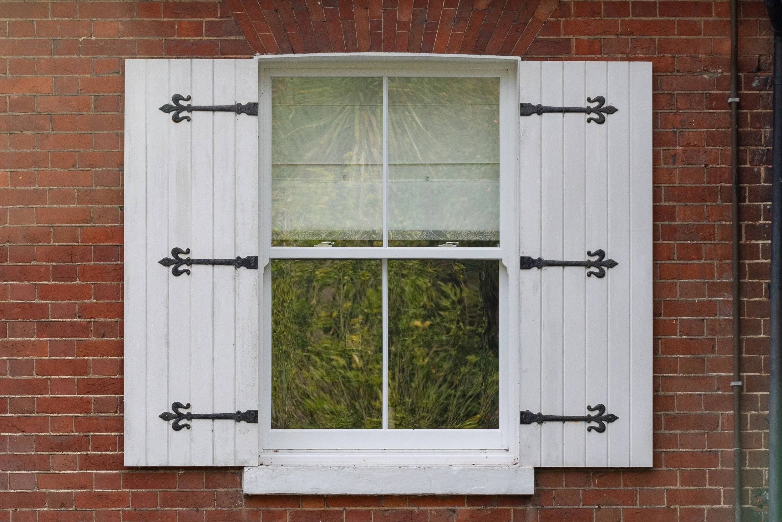 Bespoke Windows sash windows Kent-style home with white shutters